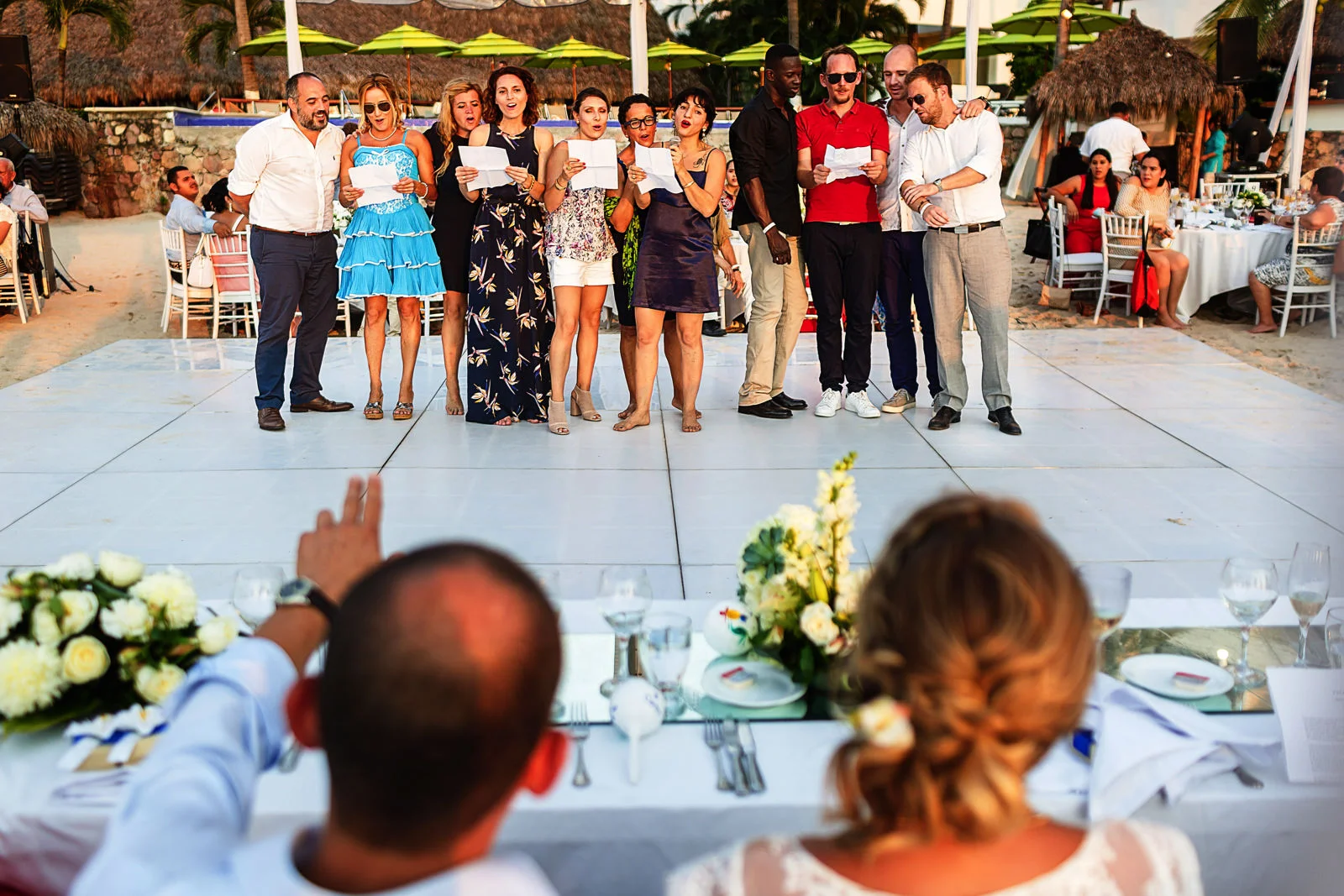 Friends of the bride singing a french song to the couple during the speeches