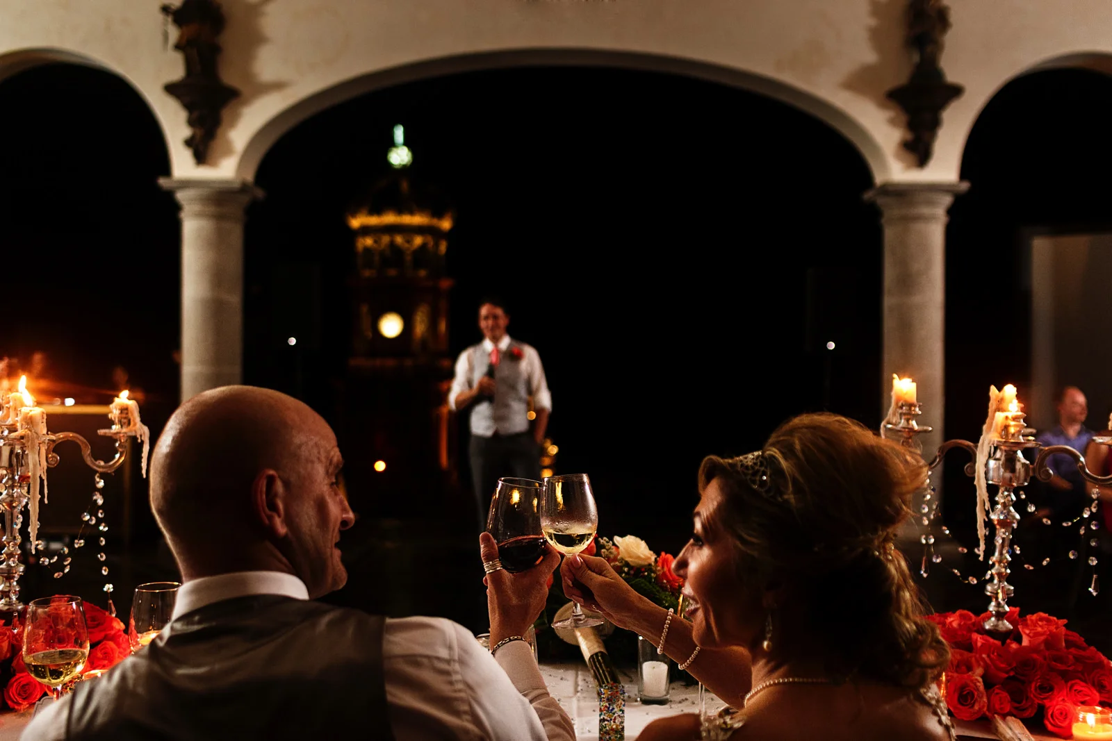 Bride and groom clink glasses after the toast