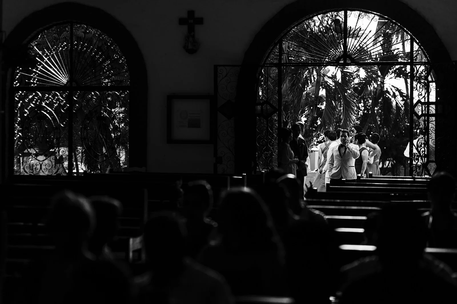 Groom waiting outside Bucerias church and making a call on his cell phone