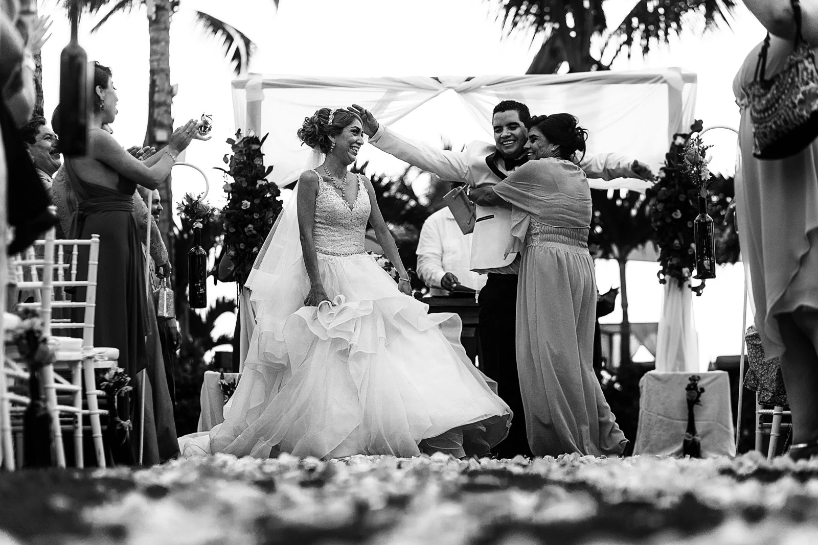 Mother of the groom hugs her sons as the civil wedding ceremony is over