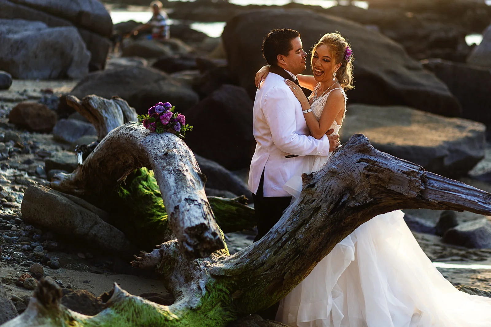 Groom and bride kissing and hugging near the pacific ocean in Puerto Vallarta