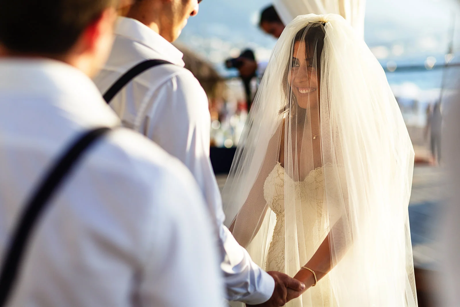 Bride looking at the groom in the during the ceremony through her veil