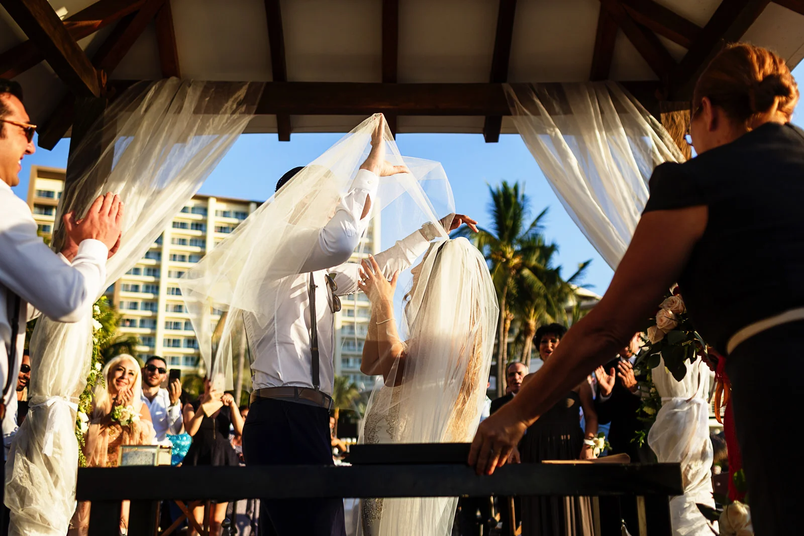 Groom lifts the bride's veil for the kiss at the end of the ceremony