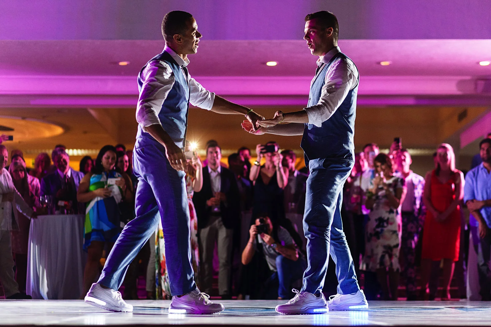 Grooms giving it all during their coreographed wedding first dance