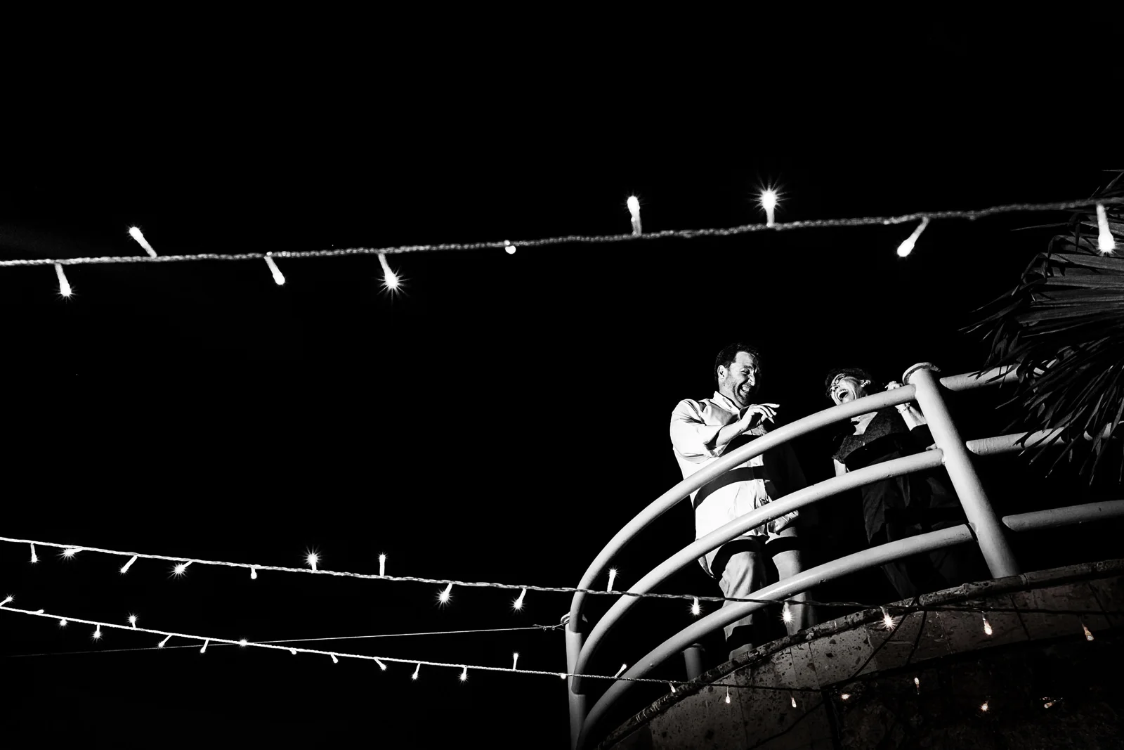 Wedding guests dancing and having a good time on the top of a staircase