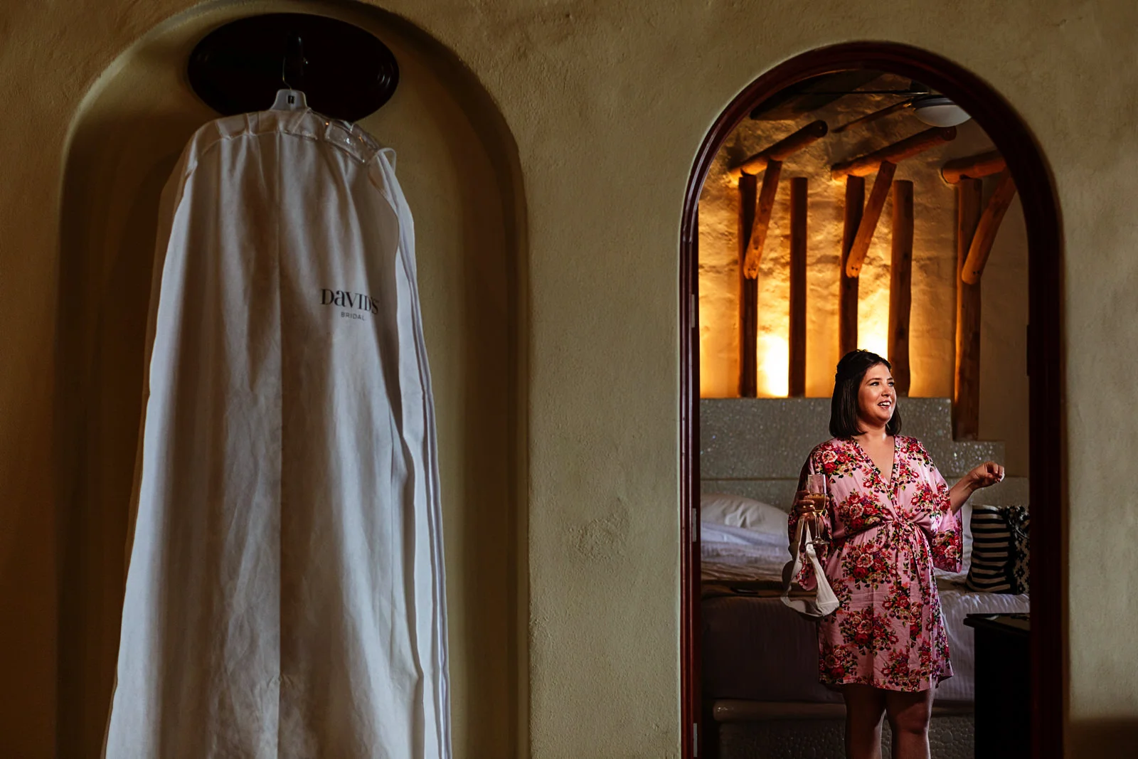 Bridesmaid standing on the room next to the wedding dress
