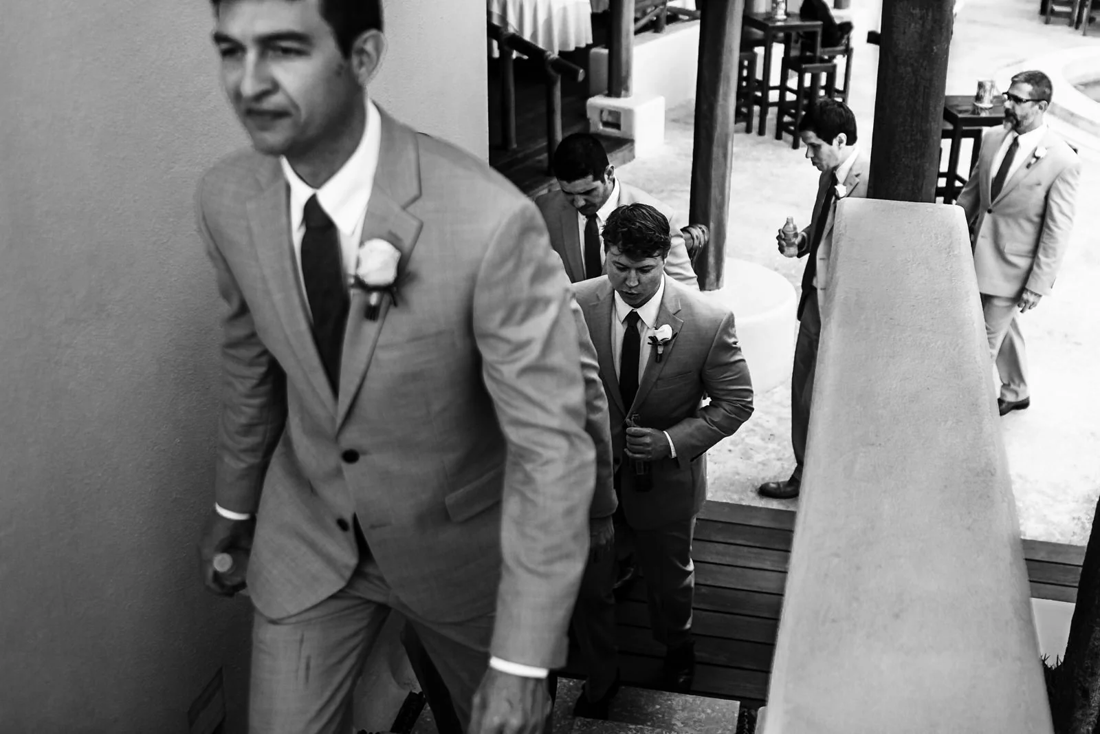 Groomsmen walking up the stairs towards the ceremony