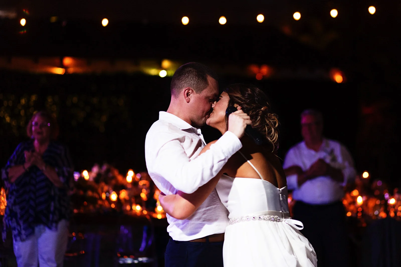 Bride kiss the groom while he sing her a song