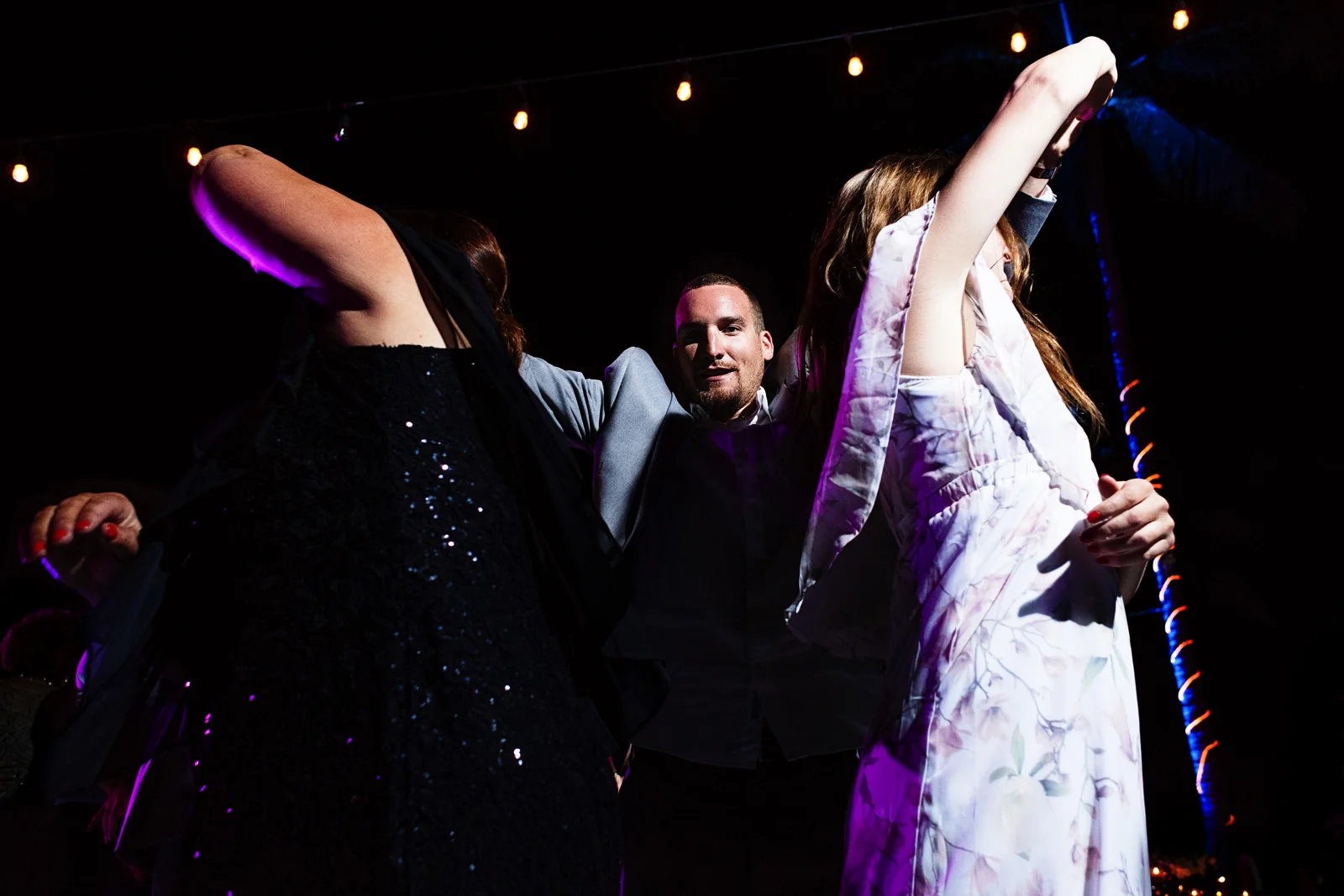 Wedding guest dancing with two girls at the same time