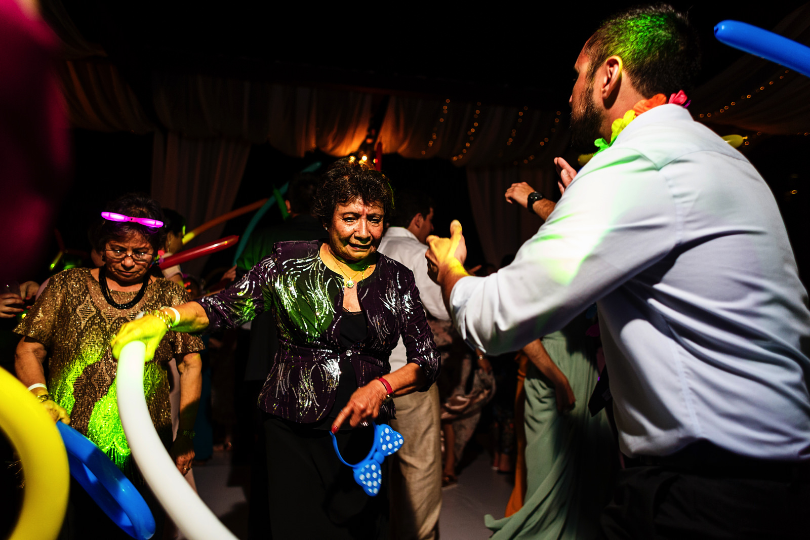 Wedding guests dancing and shaking balloons