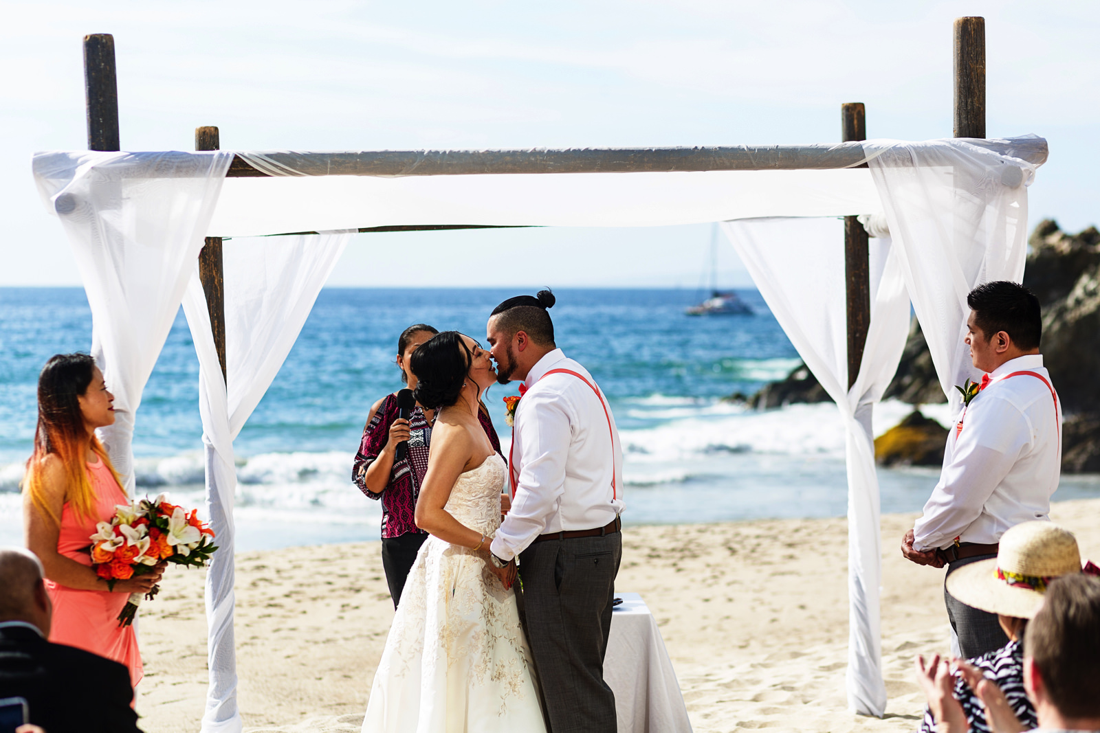 Bride and groom about to have their first kiss at the end of their wedding ceremony on the beach