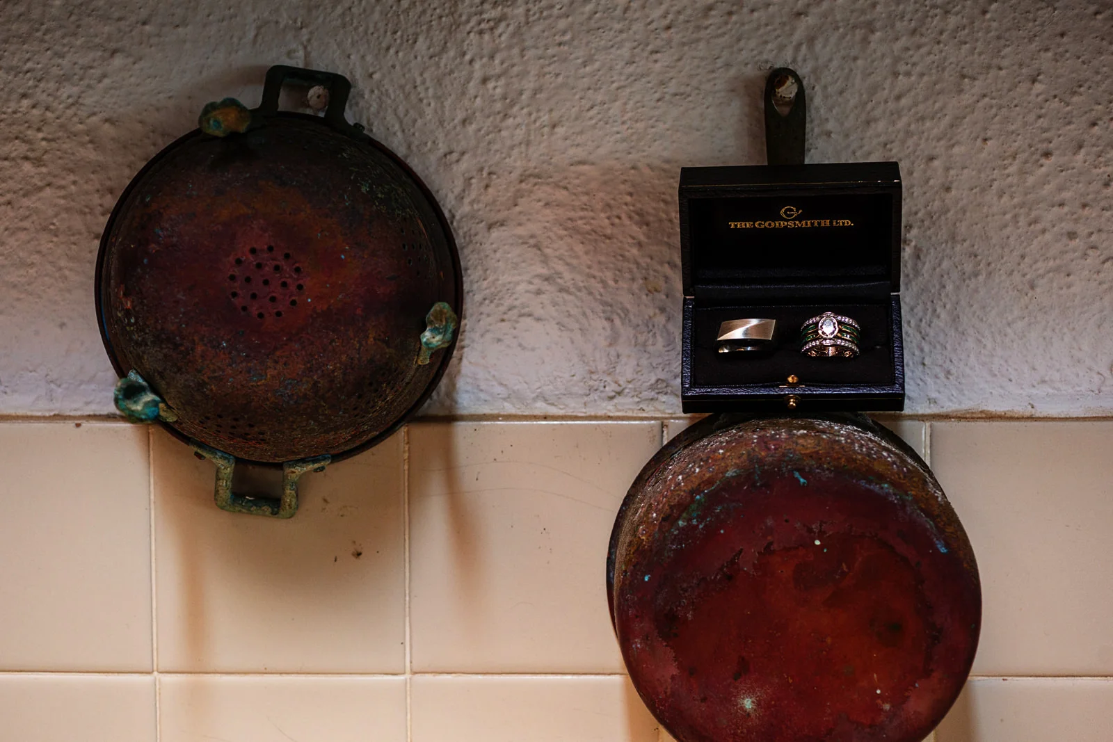 Wedding rings sitting over an old copper pot