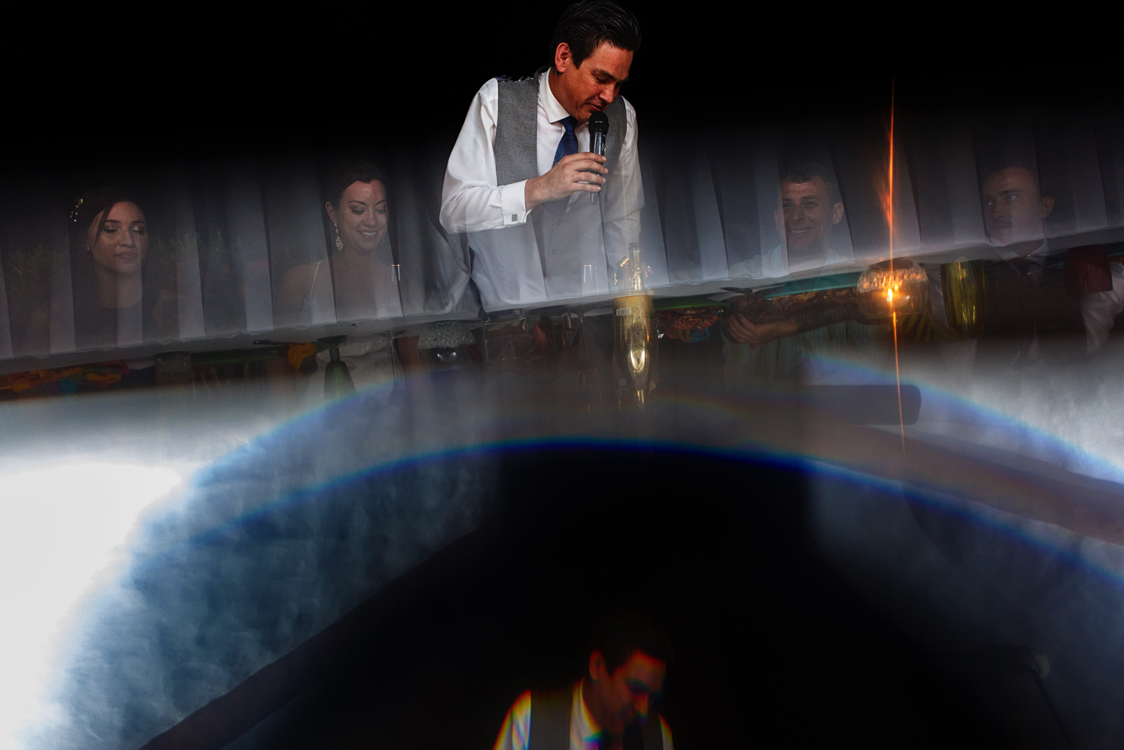 Groom’s speech creative photo using a prism reflection and flare