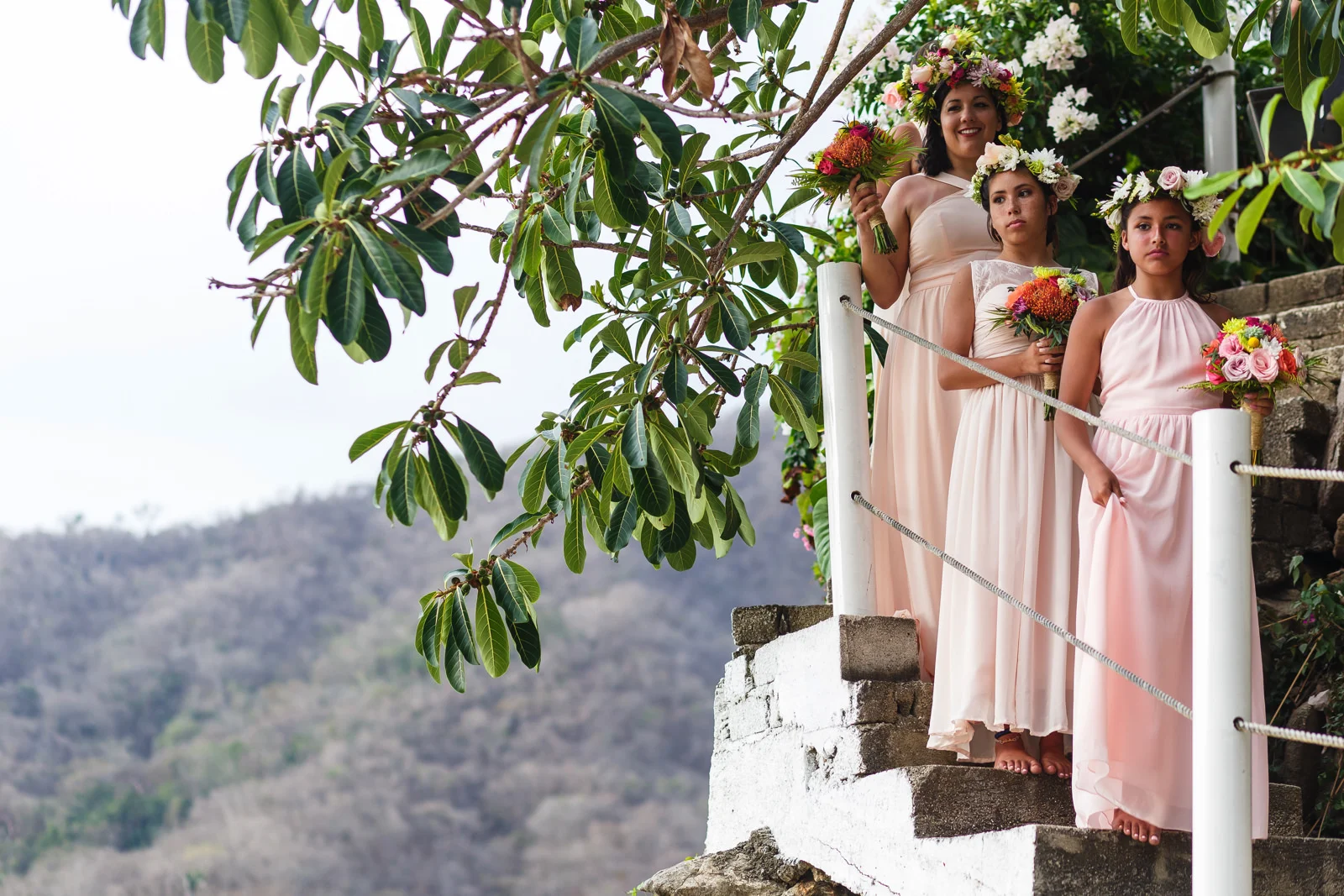Bridesmaids waiting to be call for the procesional of the wedding ceremony on the staircase of Miramar Yelapa.