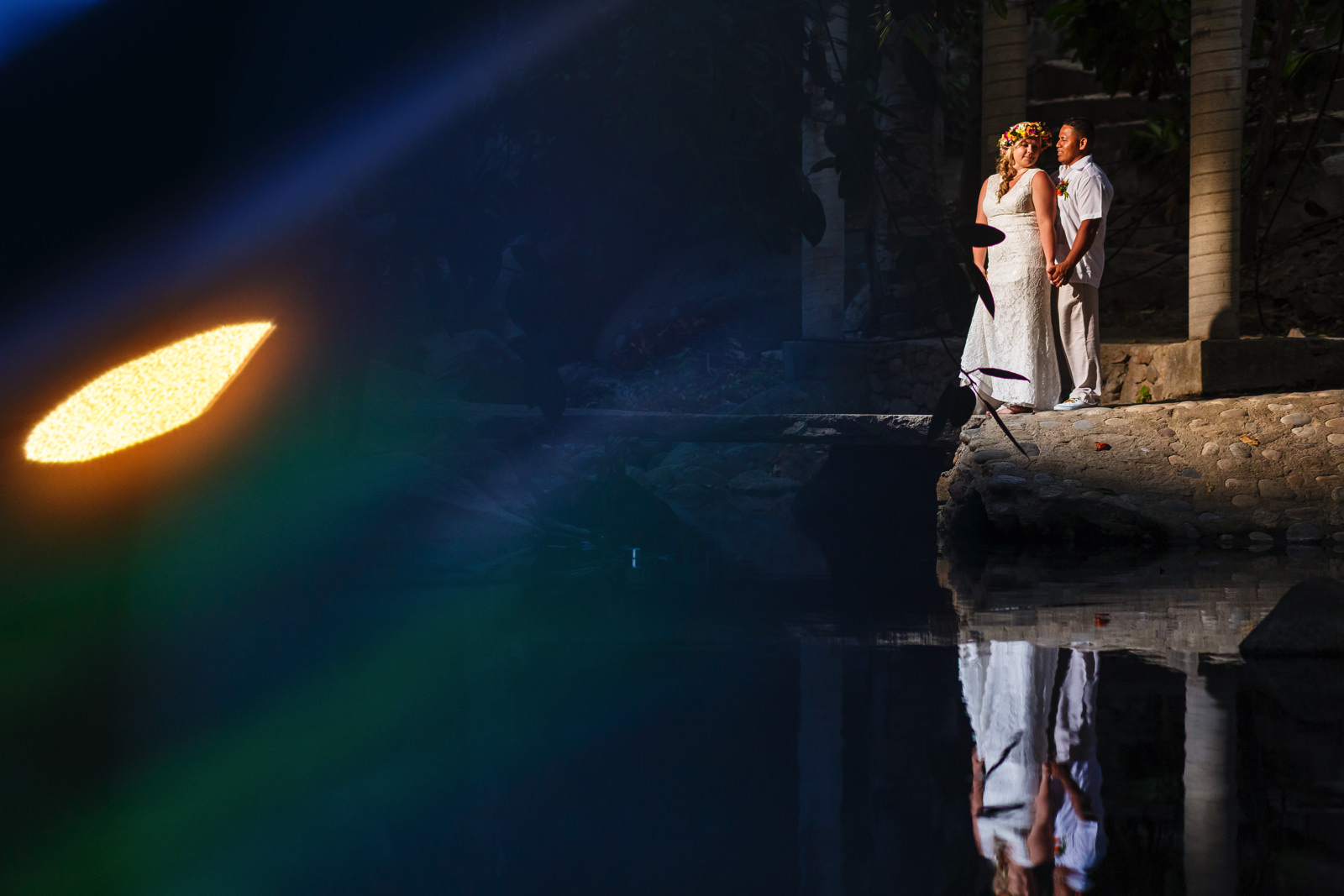 Creative bride and groom portrait over a pond in Yelapa.