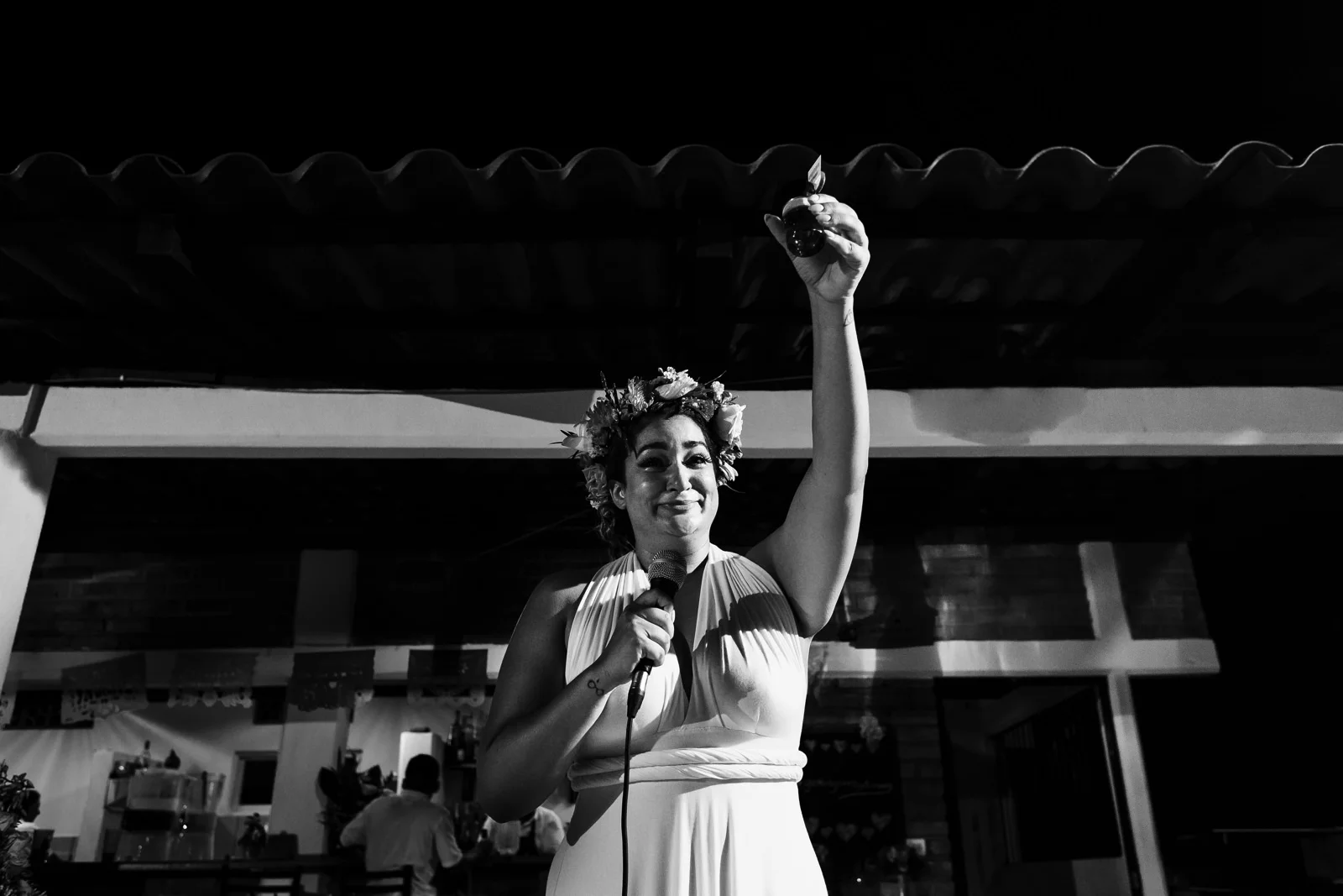 Bridesmaid raising her tequila shot at the end of her speech in the terrace at Miramar Yelapa.