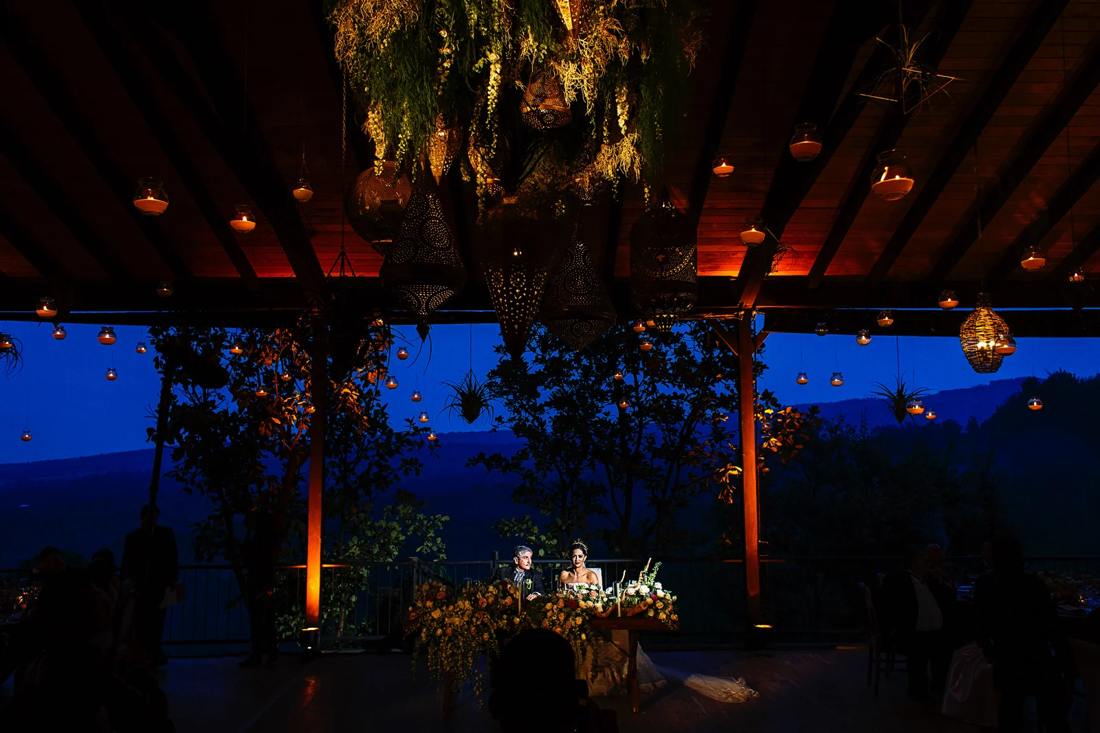 Bride and groom at their dinner table with a gorgeous background of the mountains.