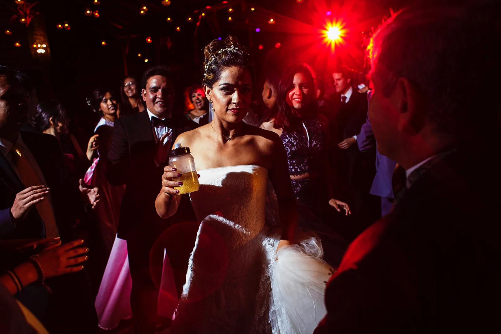 Bride, groom and guests dancing at the wedding party.