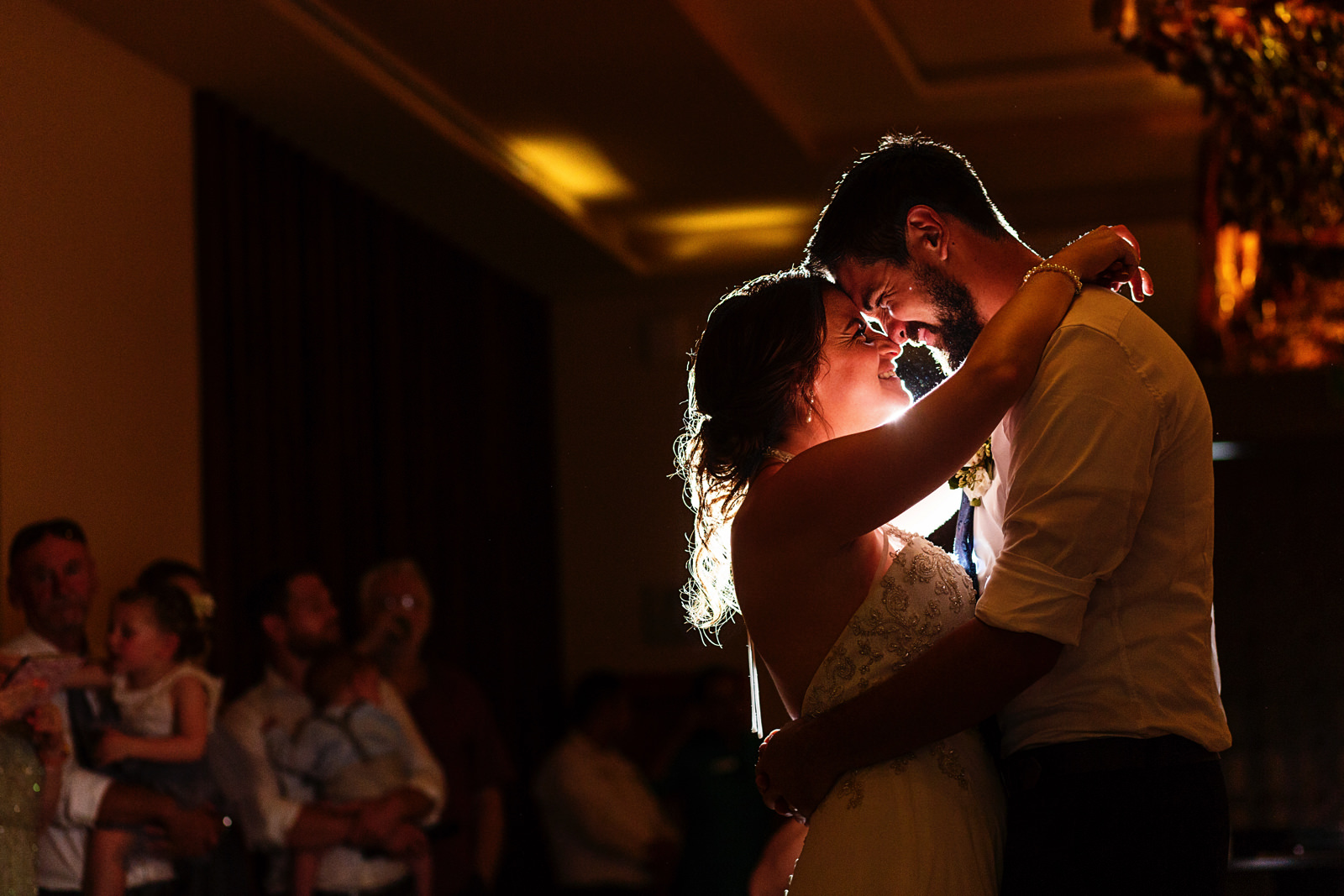Bride and groom hug and put their nose and foreheads together during their first dance at the Hyatt Ziva ballrooms.