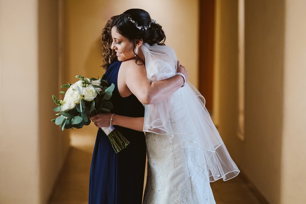 Bride and mother hug after blessing