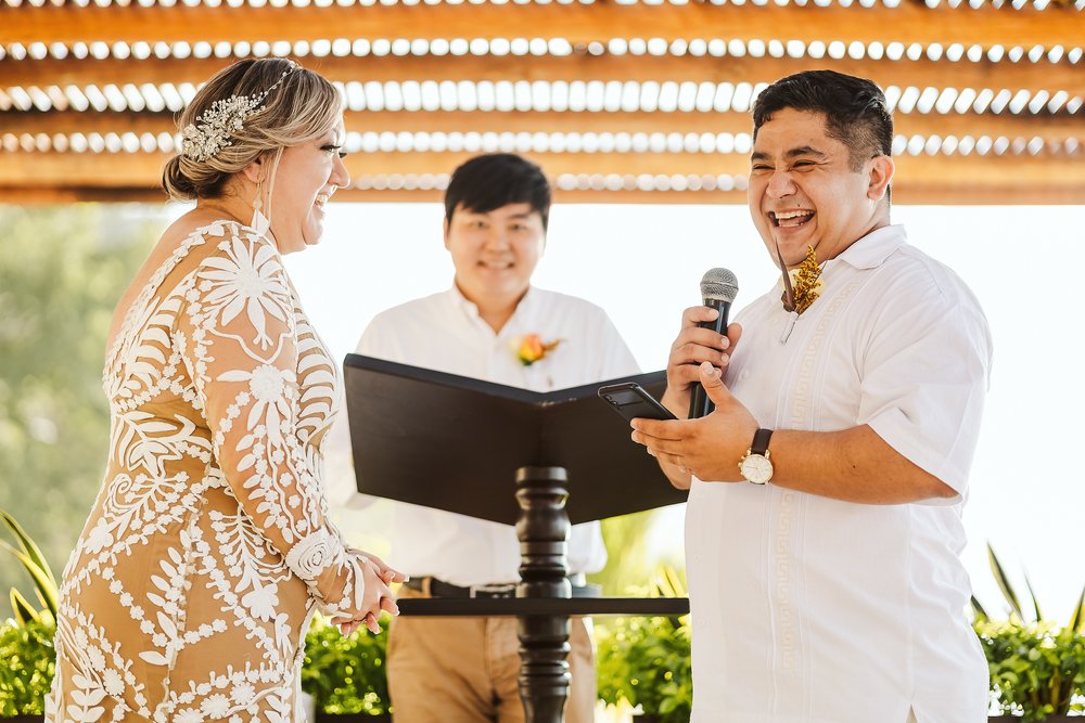 Groom making a joke at his wedding vows during the wedding ceremony