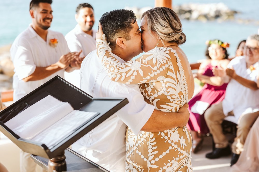 Groom and bride’s first kiss at the end of the wedding ceremony