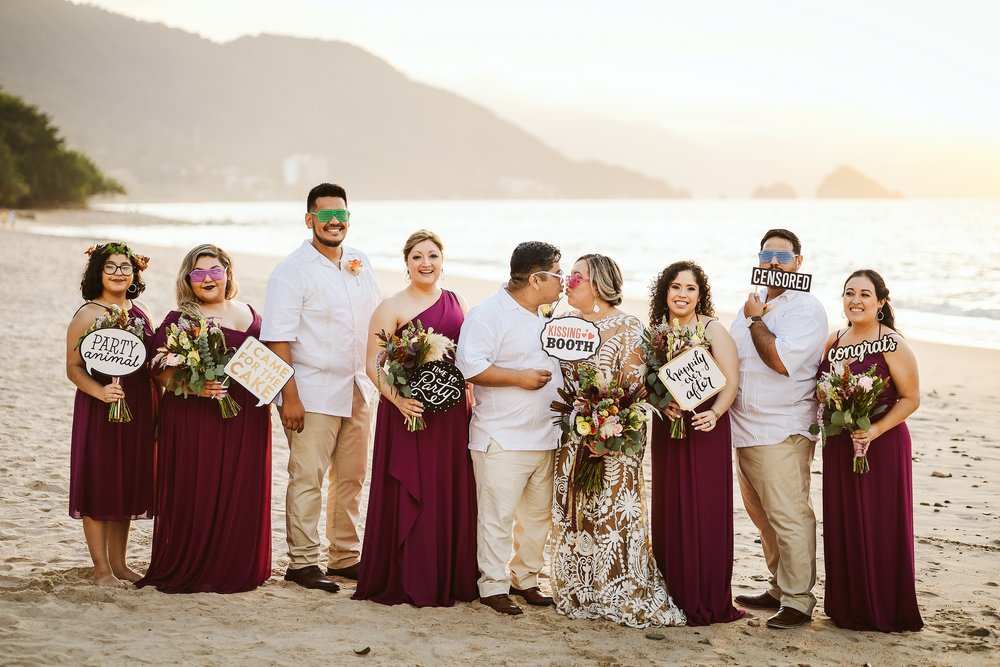 Fun portrait at Puerto Vallarta beach with bride, groom, bridesmaids, and groomsmen