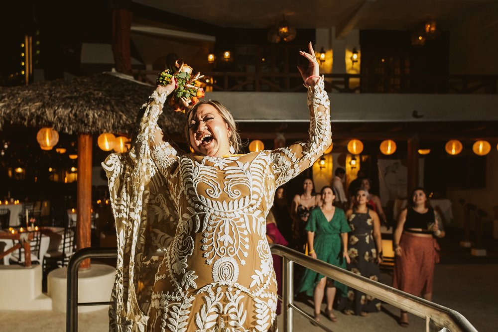 Bride tossing the bouquet with extreme energy