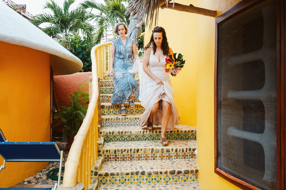 Bride and sisters walking down the stairs on their way to the wedding ceremony