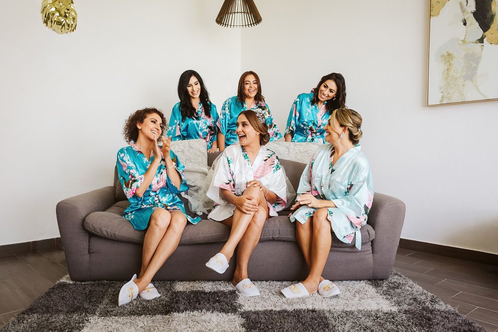 Bride and bridesmaids wearing matching robes on the bridal suite at Tizate Sea Garden