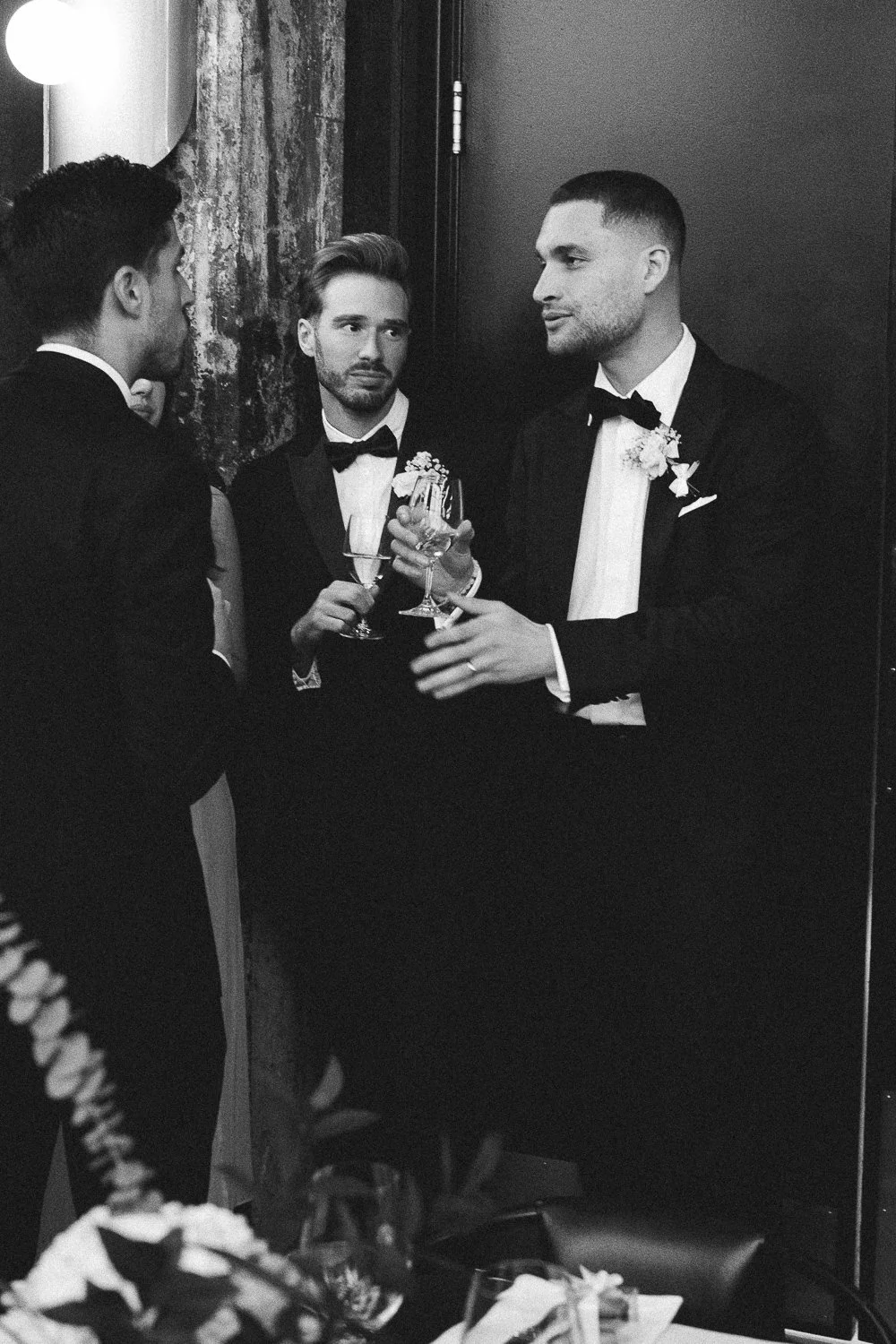groom at wedding enjoying cocktail hour with his bridal party