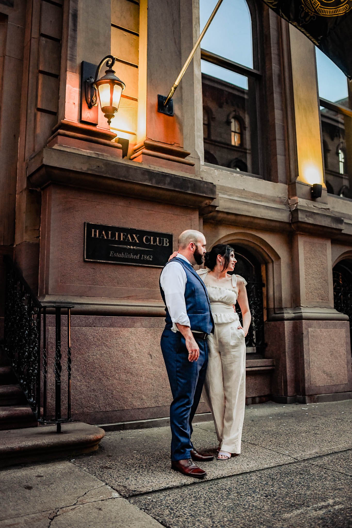 bride and groom outside halifax club watching the sun go down