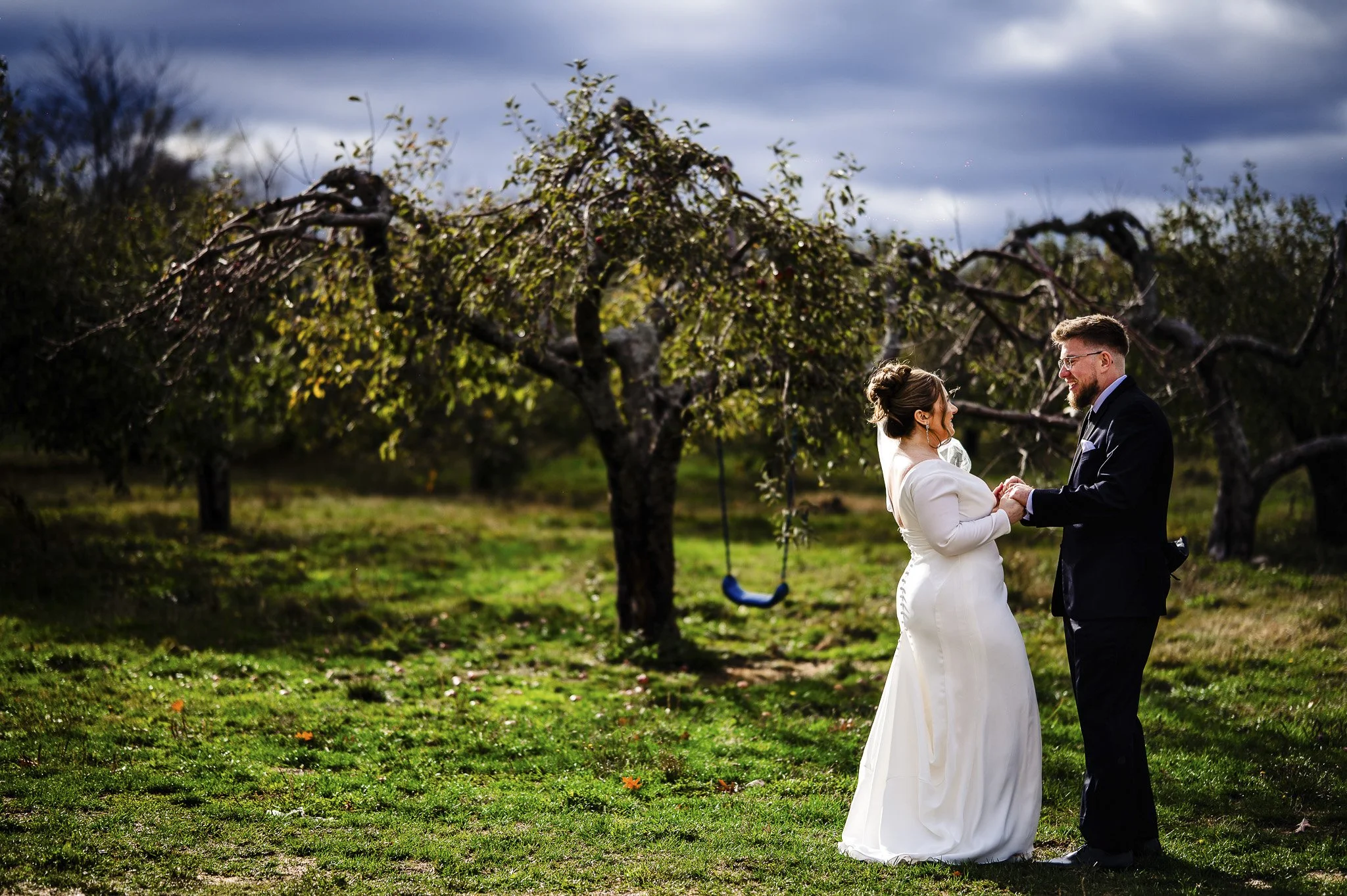 a bride and groom holding hands in a vineyard