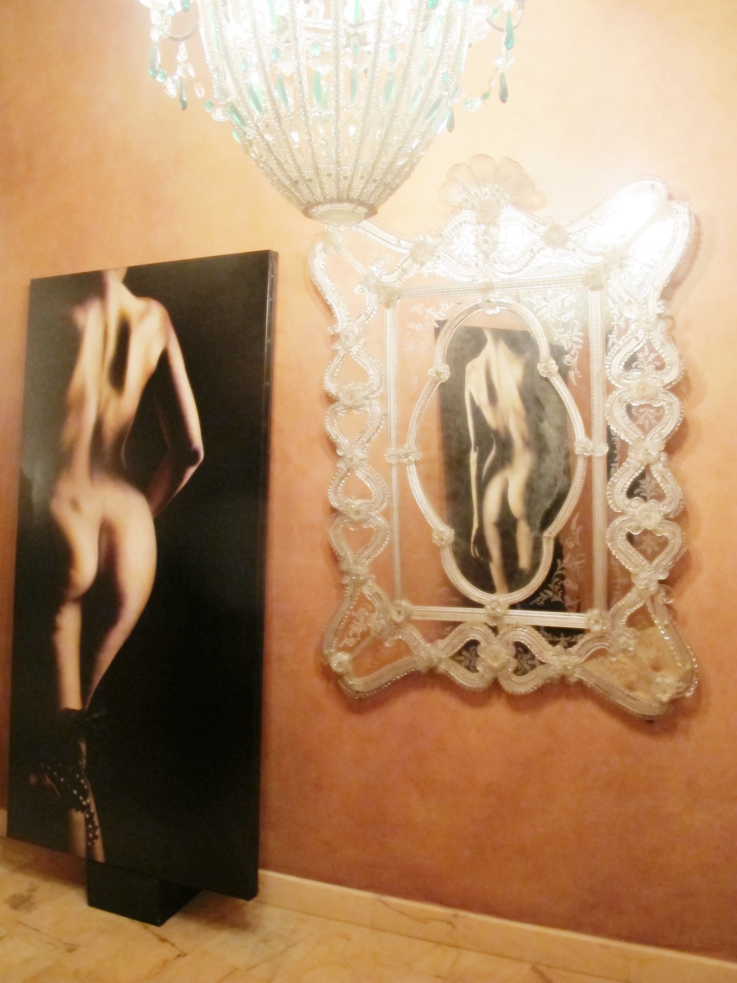 This piece is part of the "Three Graces" and the one reflected in the mirror is also part of the trio. 