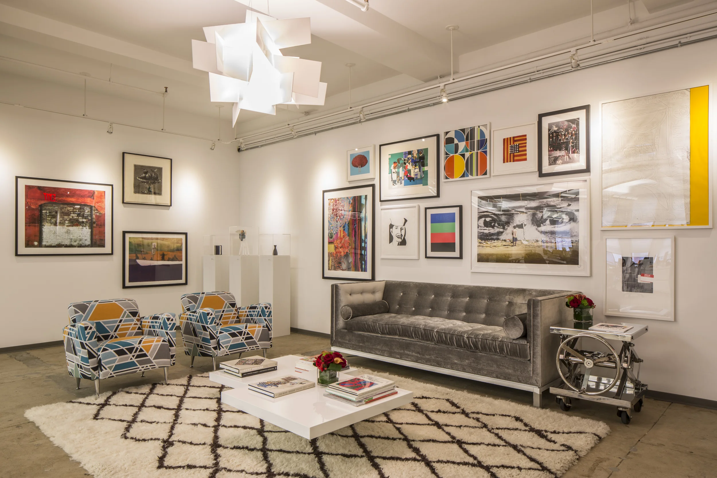 The lounge area where all the limited edition prints on the wall are by Artspace in collaboration with artists such as Assume Vivid Astro Focus and Alex Katz. The chairs were reupholstered using Sarah Morris's geometric fabric. 