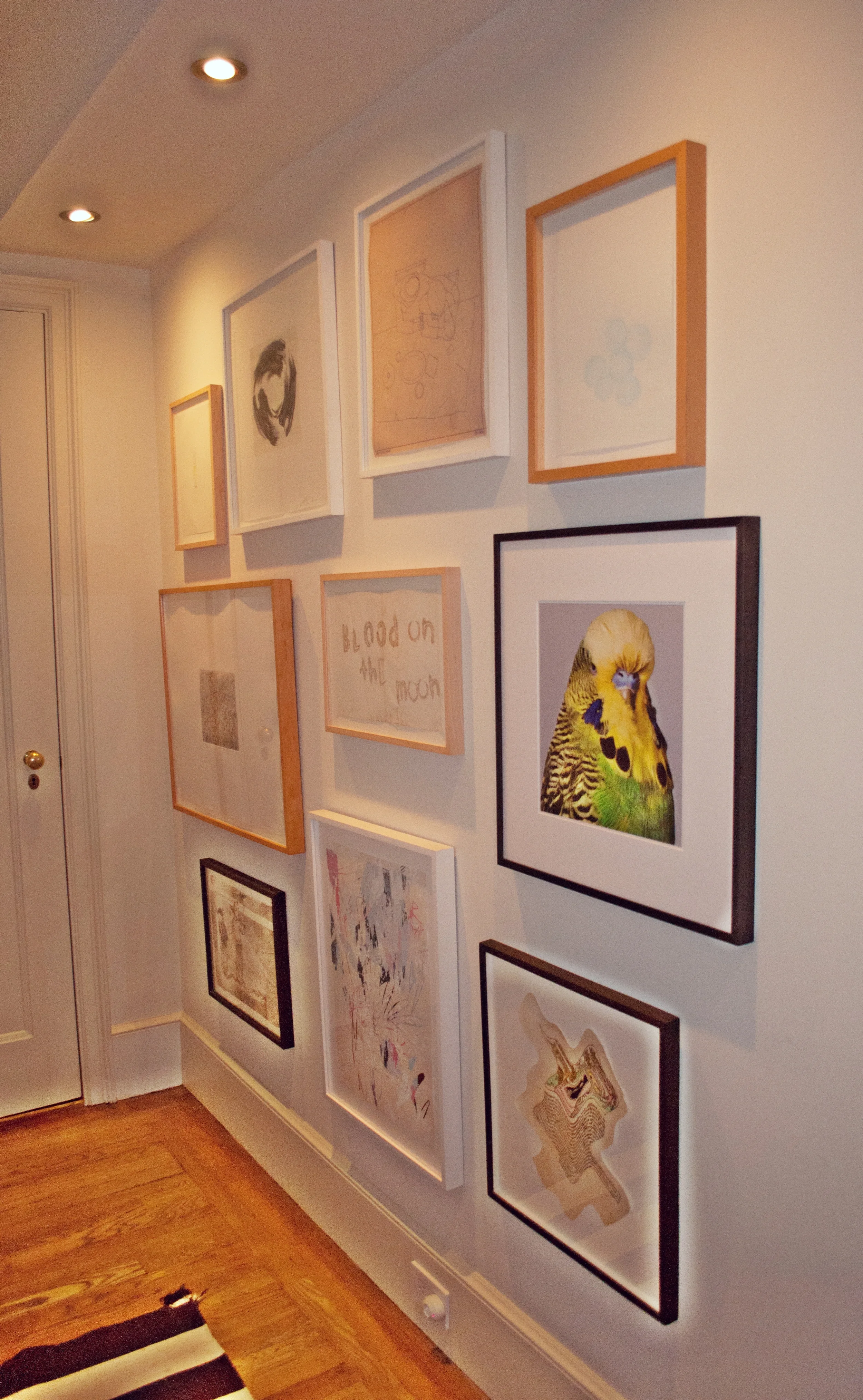 The entryway is filled with subtle works on paper hung in a gallery-style. 