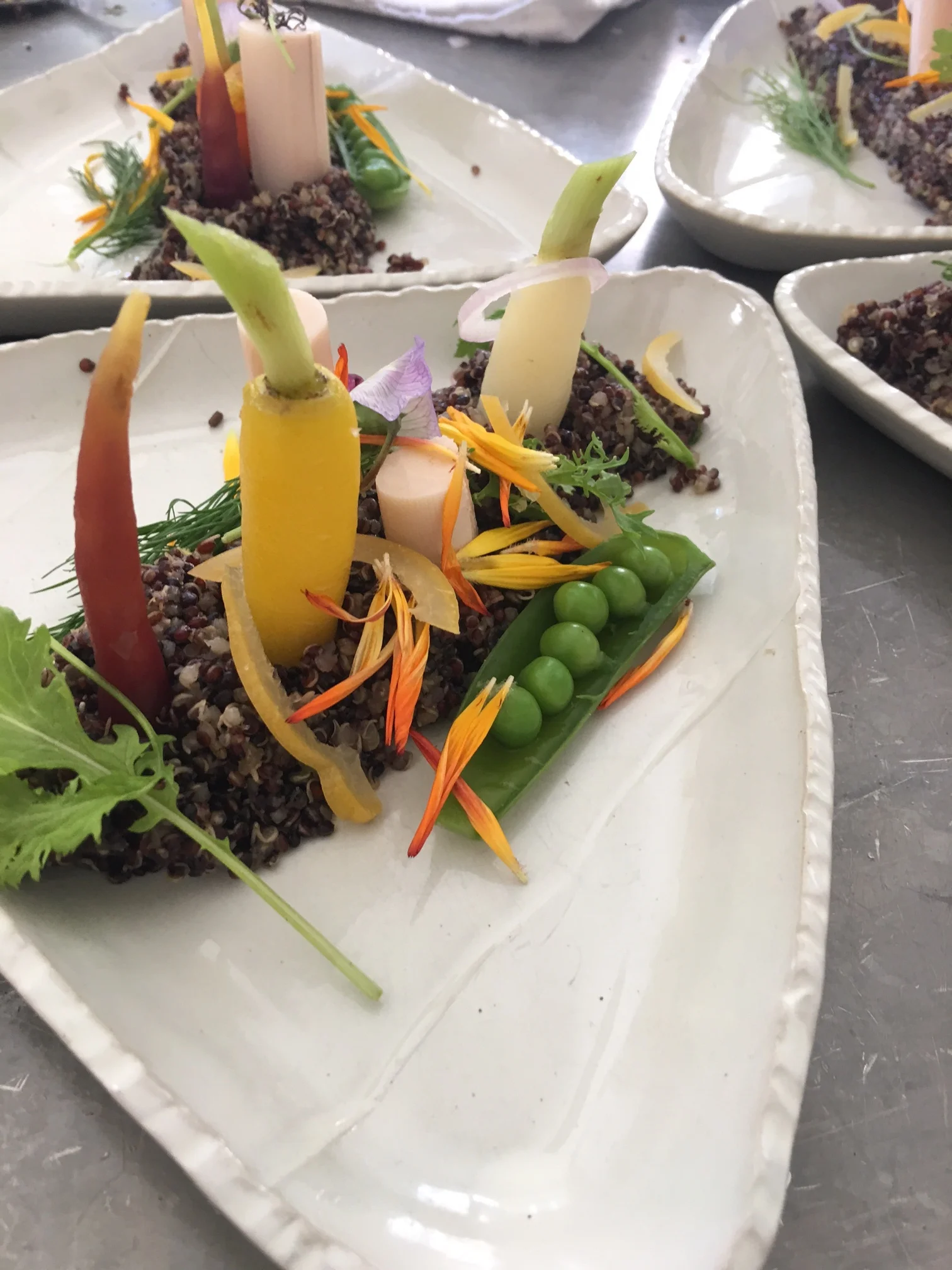 Hay buttered quinoa, poached baby carrots, hearts of palm, preserved lemon, and steamed peas