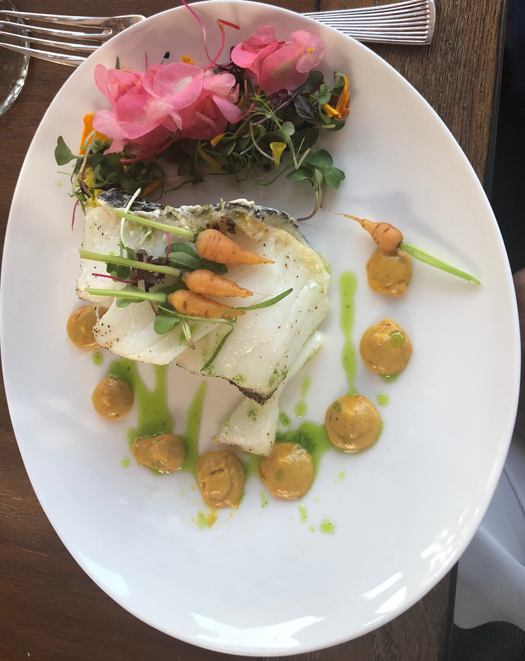 Sea bass - Olive oil poached - Tangerine Dijon sauce with Saffron, infused parsley oil, micro carrots and begonia flowers