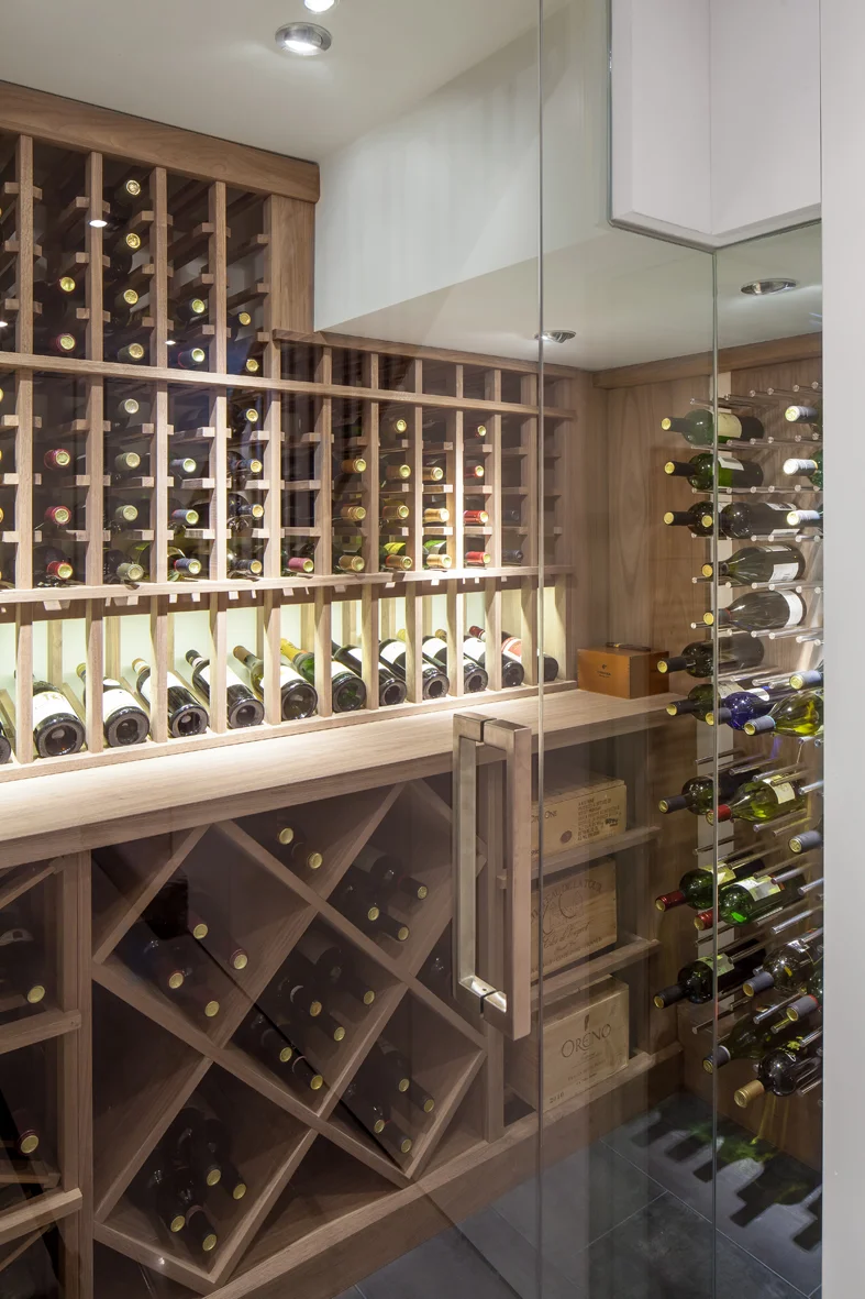 The space under the stair landing is maximized with this compact, yet elegant, wine cellar
