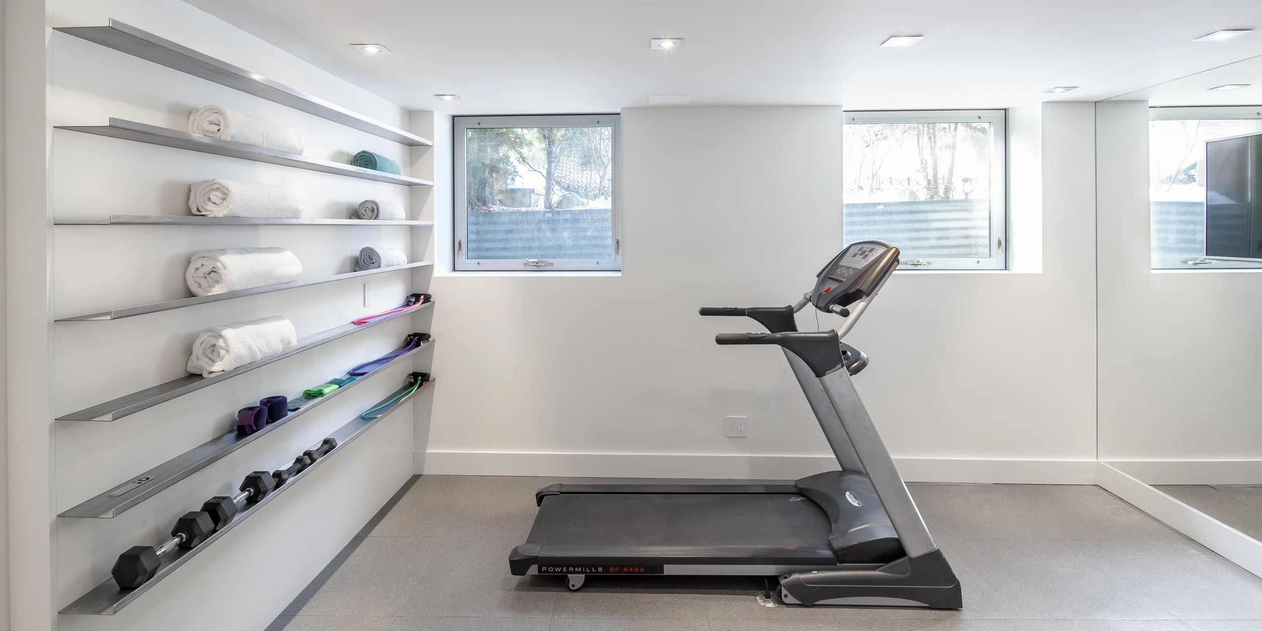 The bright fitness room links the rec room and washroom