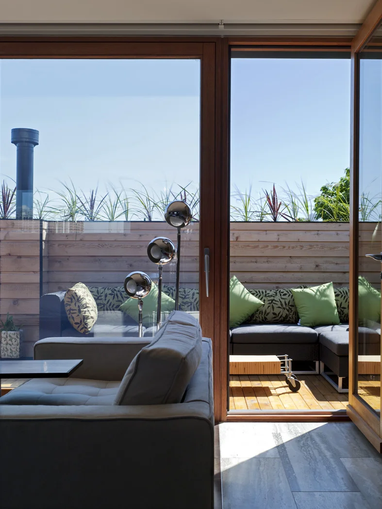 In warmer months, the full-glazed sliding door allows the room to extend to the exterior