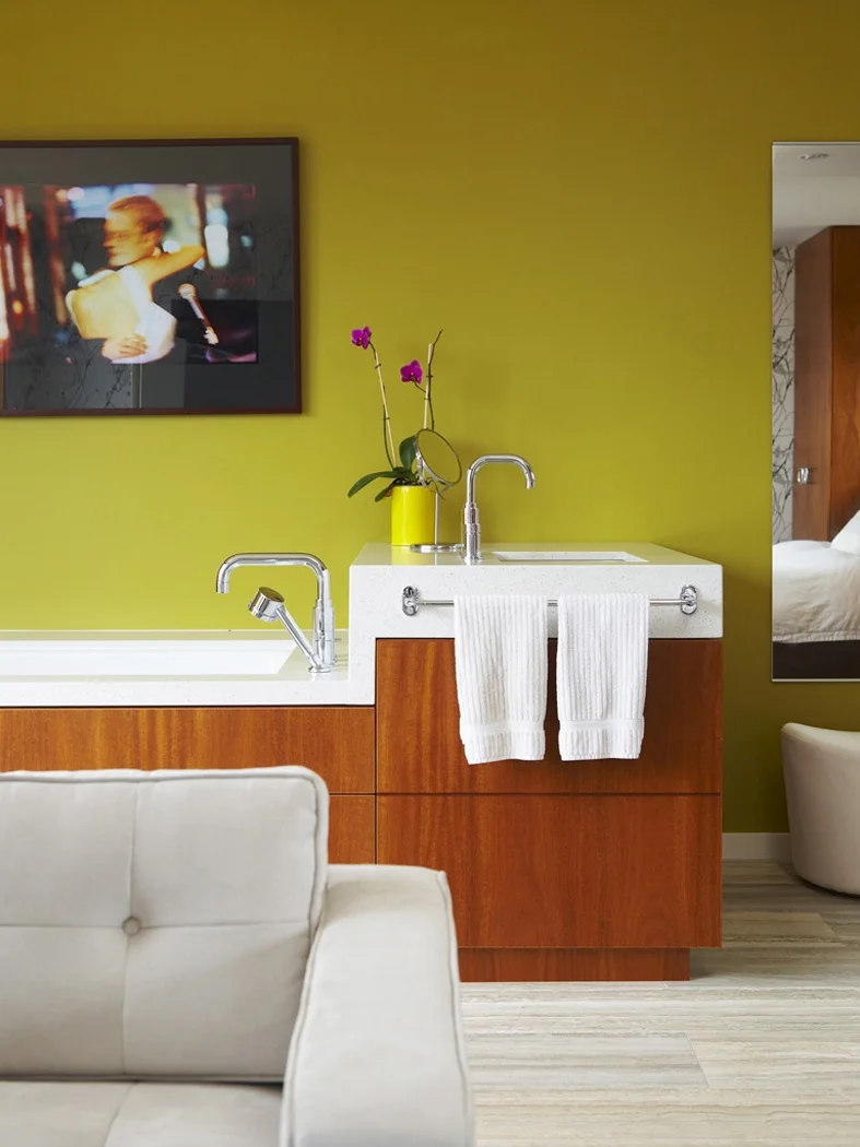 Custom-designed mahogany millwork integrating bathtub and sink into a single element 
