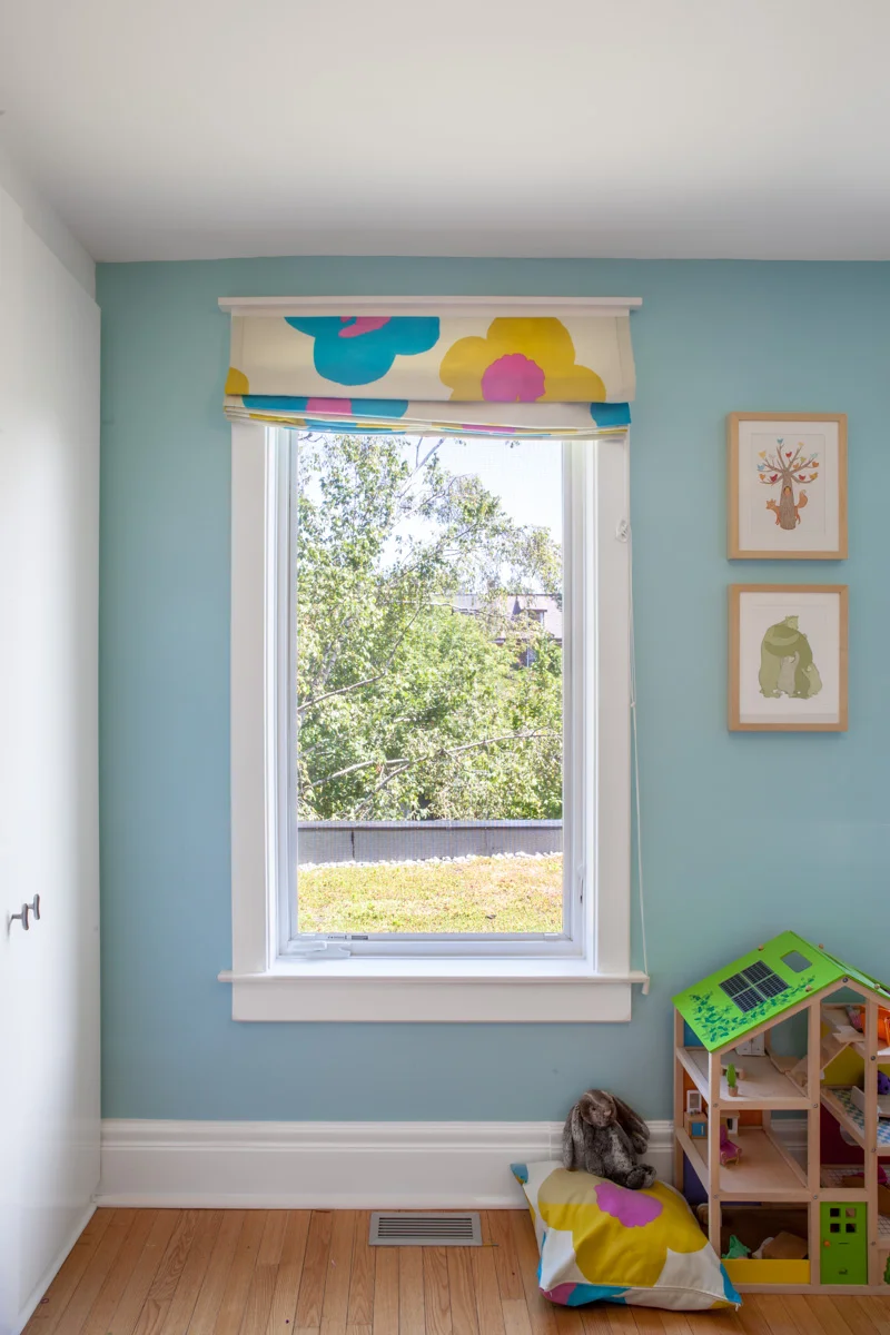 Playful, matching blinds and cushions bring life to the children's bedroom, overlooking a green roof on top of the back yard addition.