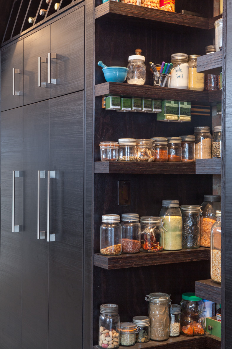Custom pantry shelves store spices and dry goods