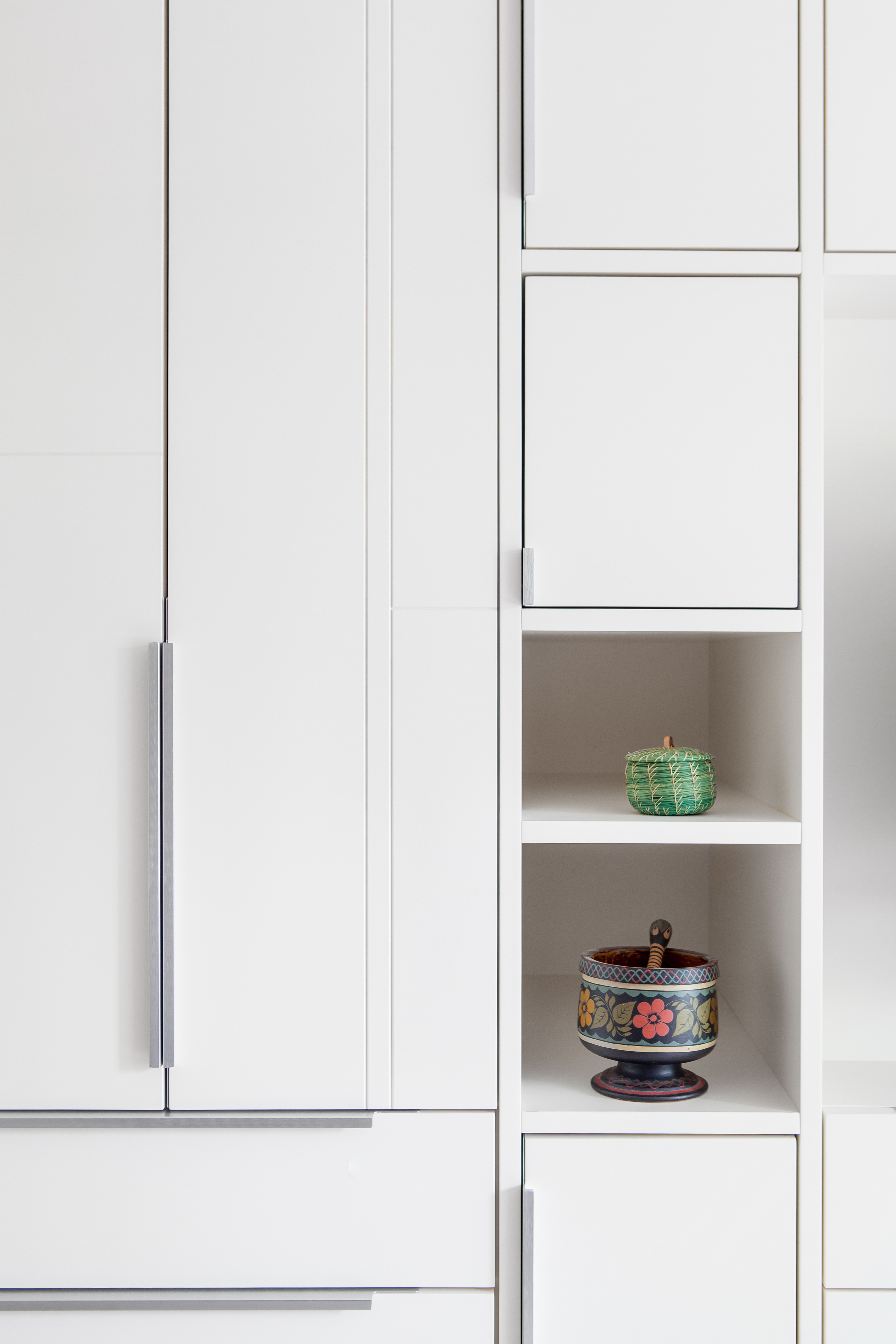 Inset doors and fine linework makes the wardrobe wall a carefully considered composition of linear elements closed storage and open display