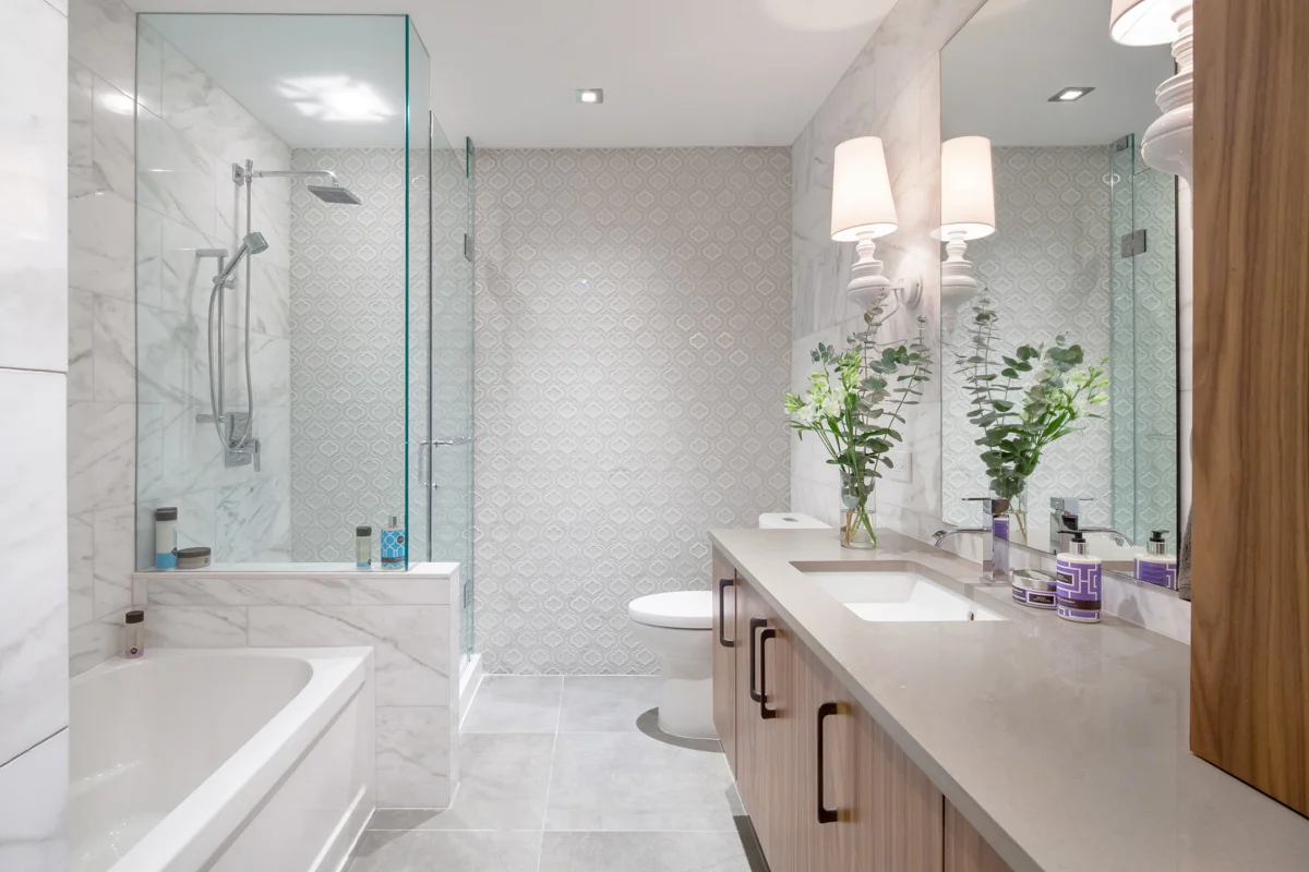 The main bathroom on the ground floor features a material palette that is luxurious, yet calming. Intended to be shared by their daughter and overnight guests, the bathroom accommodates a full size tub and walk-in shower.