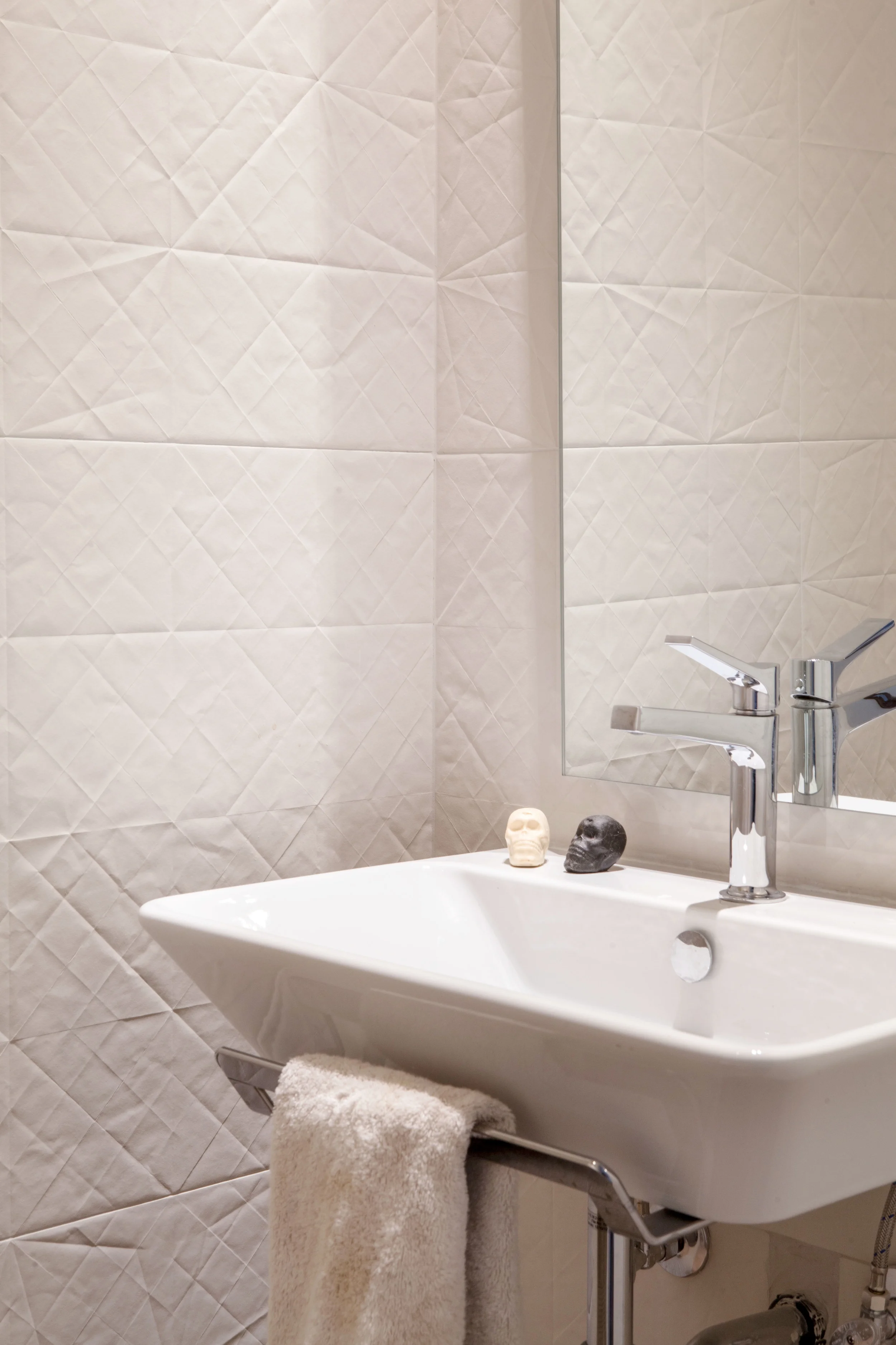 A refined palette of materials and fixtures is minimal without being sterile, and welcomes the thoughtful curation of the couple’s unique objects from their travels.