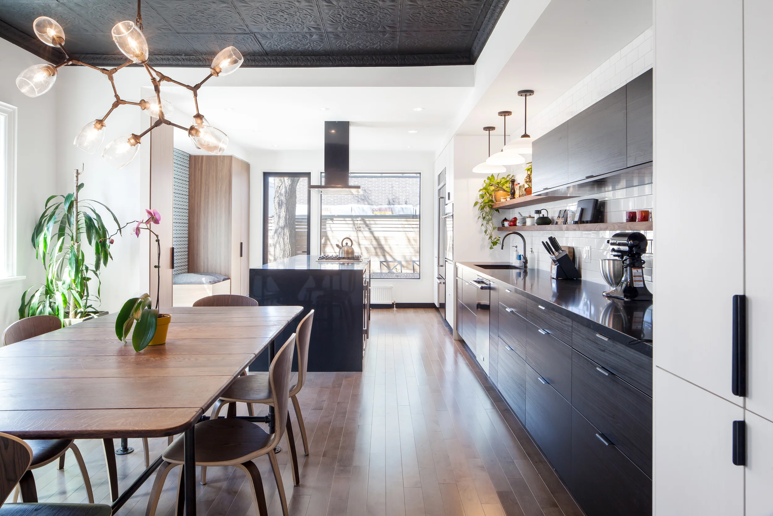 The rear of the house was radically opened up in the renovation to create a spacious room for cooking and entertaining, with plenty of natural light from south facing windows, and views to the rear yard.