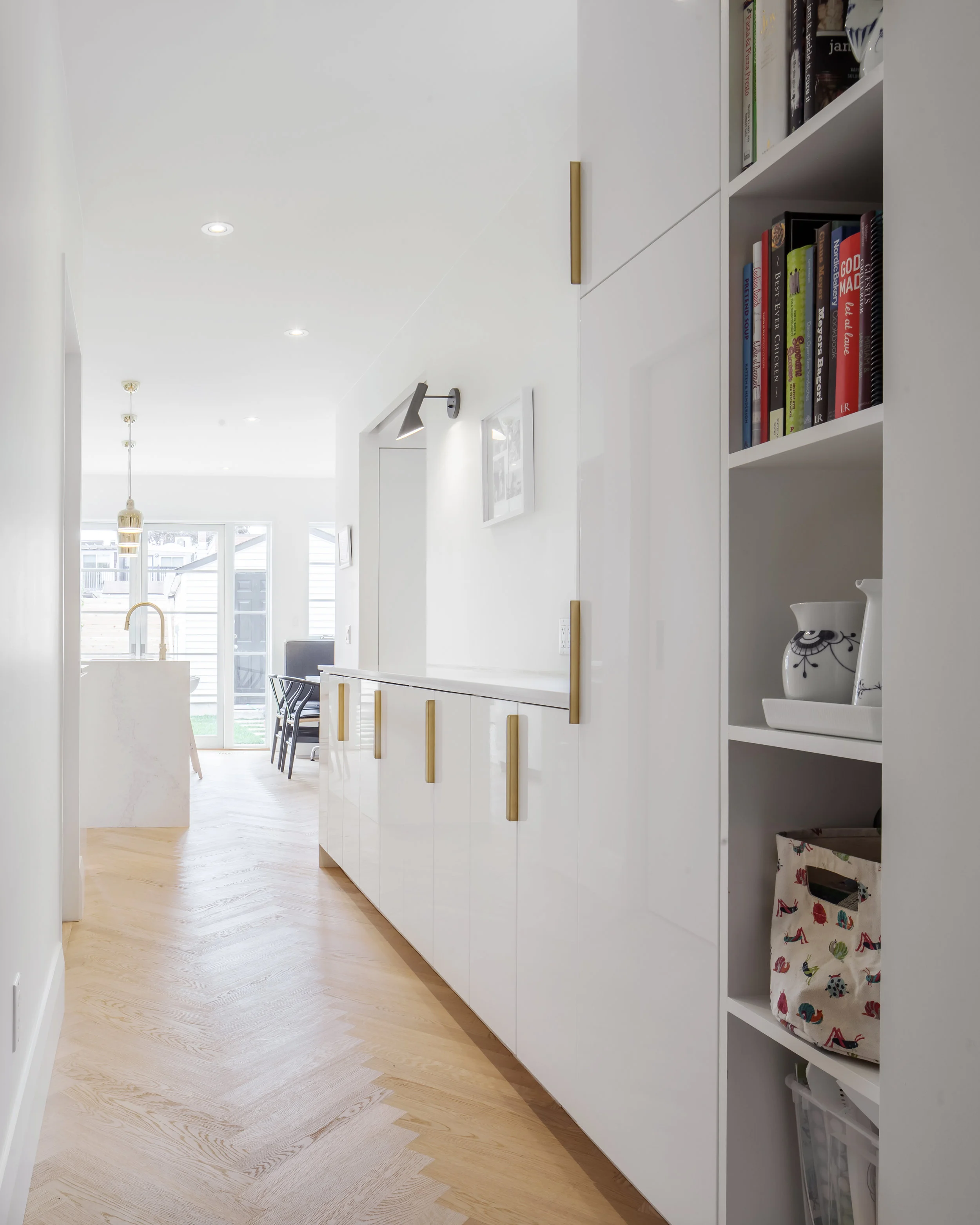 A long servery and pantry is located between the kitchen and dining room to provide spill-over prep space, and then to double as a perfect area to serve food when there are guests.