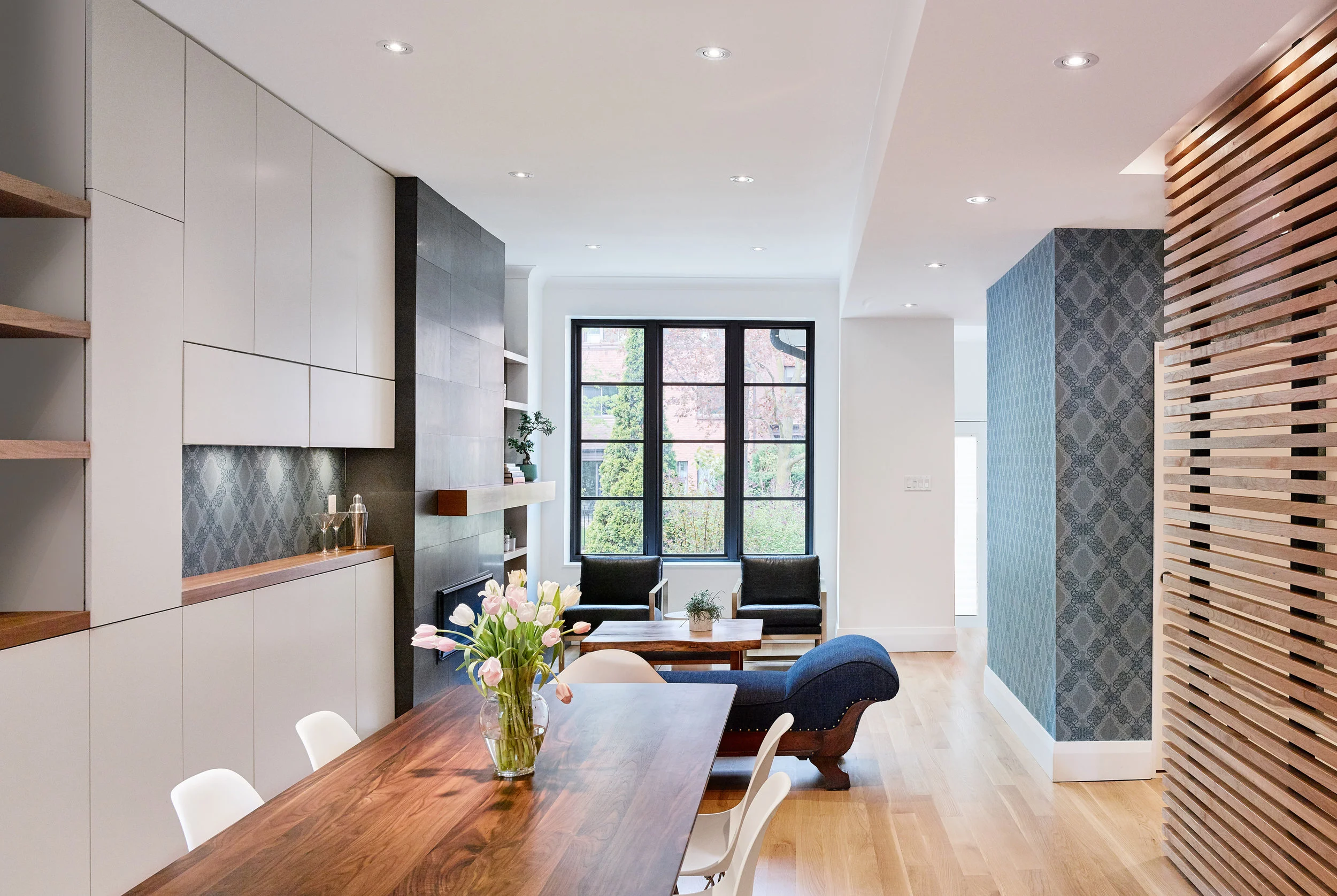 The open plan allows natural light and views to the street from both the dining and living room.